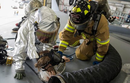 Firemen from the 628th Civil Engineering squadron extract Airman 1st Class Emilee Sharp from a fuel tank on the top of a C-17 Globemaster III April 17, 2015 during a Fuel Tank Extraction exercise at Joint Base Charleston, S.C. (U.S. Air Force photo/Senior Airman Jared Trimarchi)

