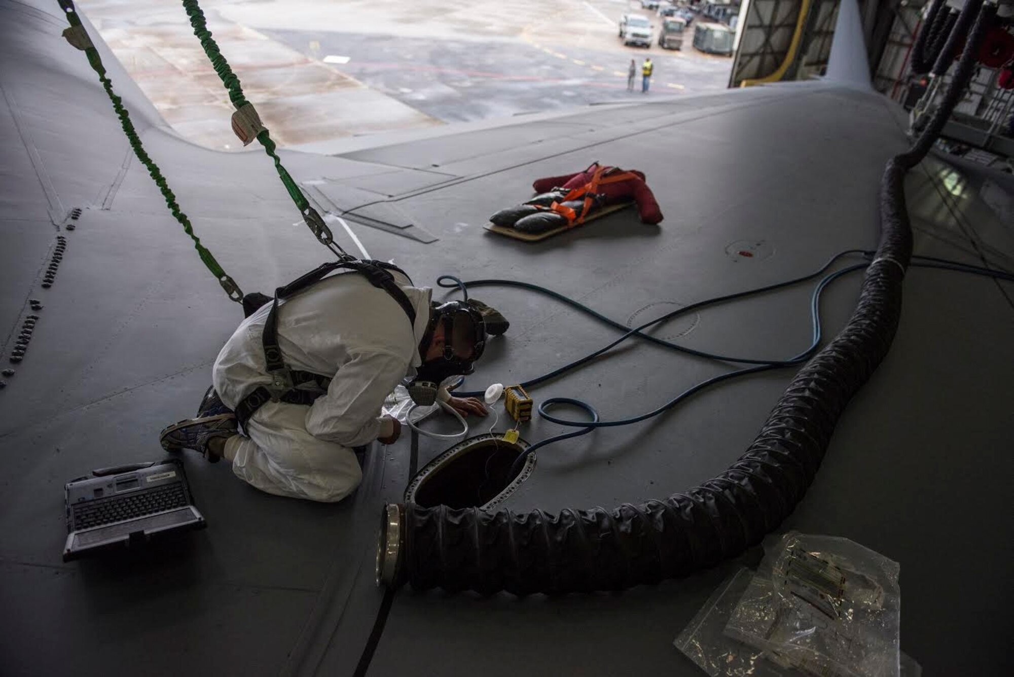 Airman 1st Class Brandon Batista looks into a fuel tank on the top of a C-17 Globemaster III April 17, 2015 during a Fuel Tank Extraction exercise at Joint Base Charleston, S.C. The exercise simulated an Airman being overcome by fumes inside a fuel tank.  First responders from the 628th Civil Engineering Squadron performed the extraction as part of the exercise. (U.S. Air Force photo/Senior Airman Jared Trimarchi) 

