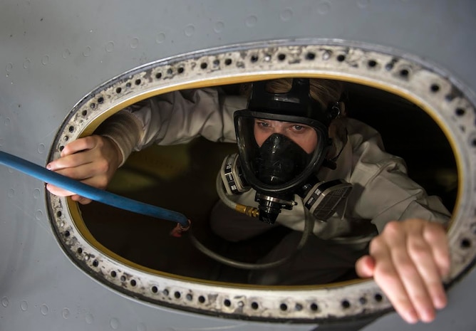 Airman 1st Class Emilee Sharp gets inside of a fuel tank on the top of a C-17 Globemaster III April 17, 2015 during a Fuel Tank Extraction exercise at Joint Base Charleston, S.C. The exercise simulated an Airman being overcome by fumes inside a fuel tank requiring first responders from the 628th Civil Engineering Squadron to conduct an extraction. (U.S. Air Force photo/Senior Airman Jared Trimarchi)


