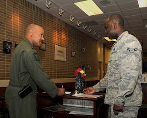 Airman 1st Class James Asilevi, 11th Logistics Readiness Squadron Traffic Management journeyman, assists Lt. Col Rod Chandler, 150th Special Operations Squadron detachment commander, as he signs in at the 11th LRS Traffic Management Office April 20, 2015, on Joint Base Andrews, Md.  During the summer months, there is a significant increase of service members who visit TMO as they change duty stations. (U.S. Air Force photo/Senior Airman Preston Webb)