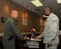 Airman 1st Class James Asilevi, 11th Logistics Readiness Squadron Traffic Management journeyman, assists Lt. Col Rod Chandler, 150th Special Operations Squadron detachment commander, as he signs in at the 11th LRS Traffic Management Office April 20, 2015, on Joint Base Andrews, Md.  During the summer months, there is a significant increase of service members who visit TMO as they change duty stations. (U.S. Air Force photo/Senior Airman Preston Webb)