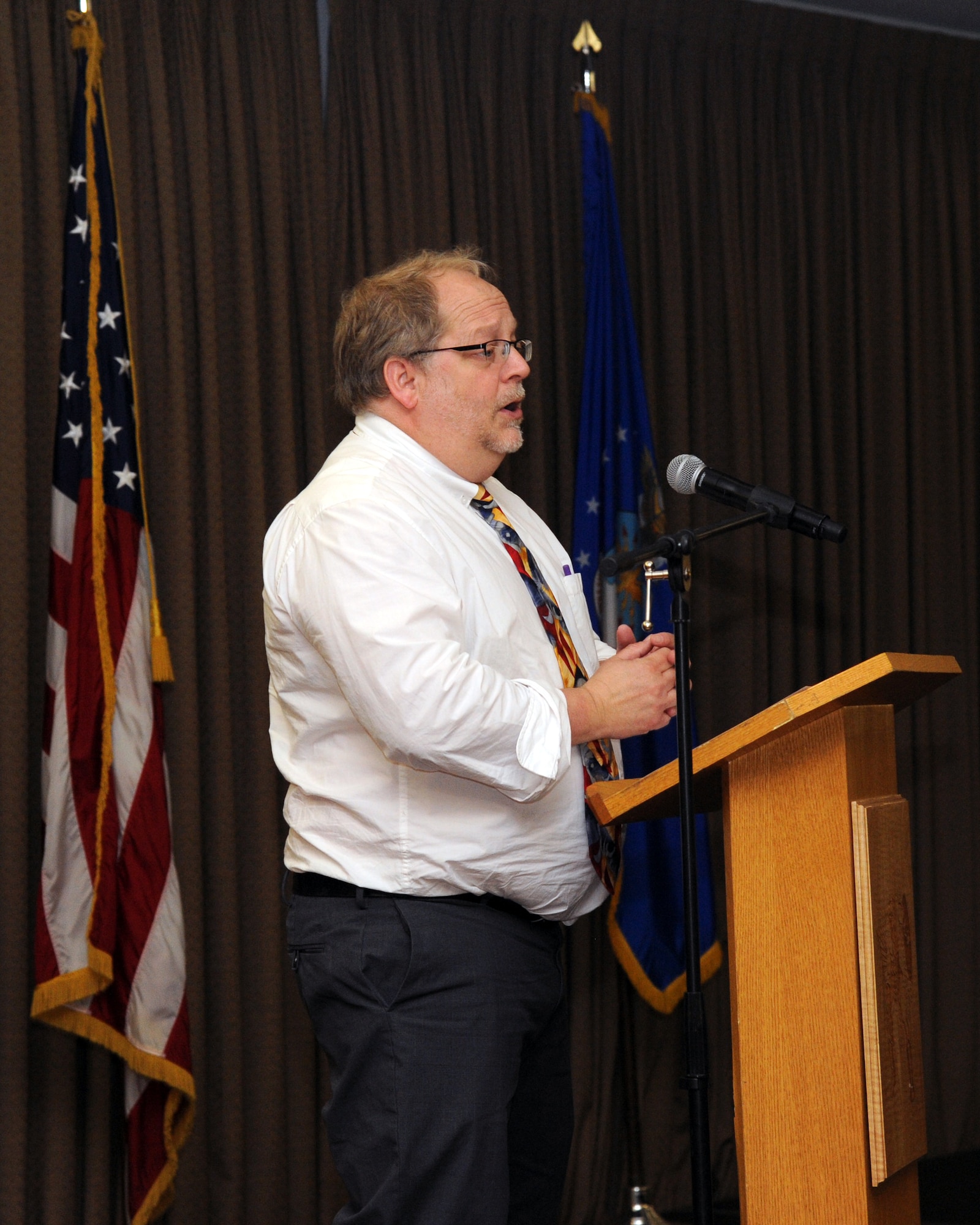 Professor John K. Cox, North Dakota State University department head of history, philosophy and religious studies, speaks to an audience of more than 50 attendees during a luncheon about the Holocaust and the history surrounding it, at the Northern Lights Club ballroom Apr. 16, 2015. The purpose of Cox’s appearance was to not only educate people further on the Holocaust, but also to promote awareness of cultural understanding and the possibilities that come with finding more peaceful solutions to problems. (U.S. Air Force photo by Senior Airman Zachiah Roberson/released)