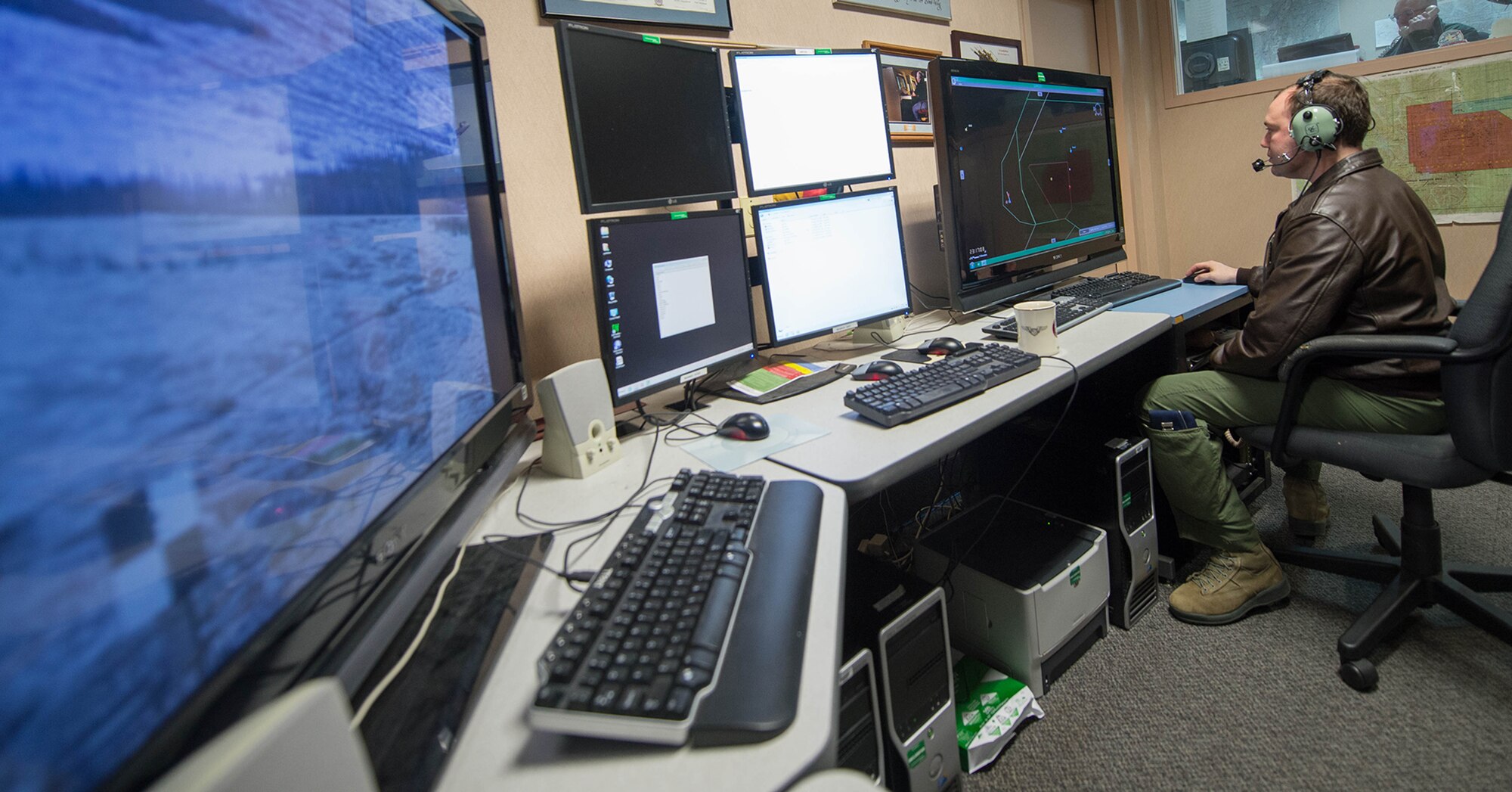 Capt. Matthew Mendenhall, a 353rd Combat Training Squadron baron controller, operates live, virtual and constructive training, April 16, 2015, in preparation for RED FLAG-Alaska 15-2 at Eielson Air Force Base, Alaska. The LVC uses software to integrate virtual cockpits, computer generated forces, live weapons platforms and real life assets fused together to produce a battlefield for training. (U.S. Air Force photo by Staff Sgt. Shawn Nickel/Released) 