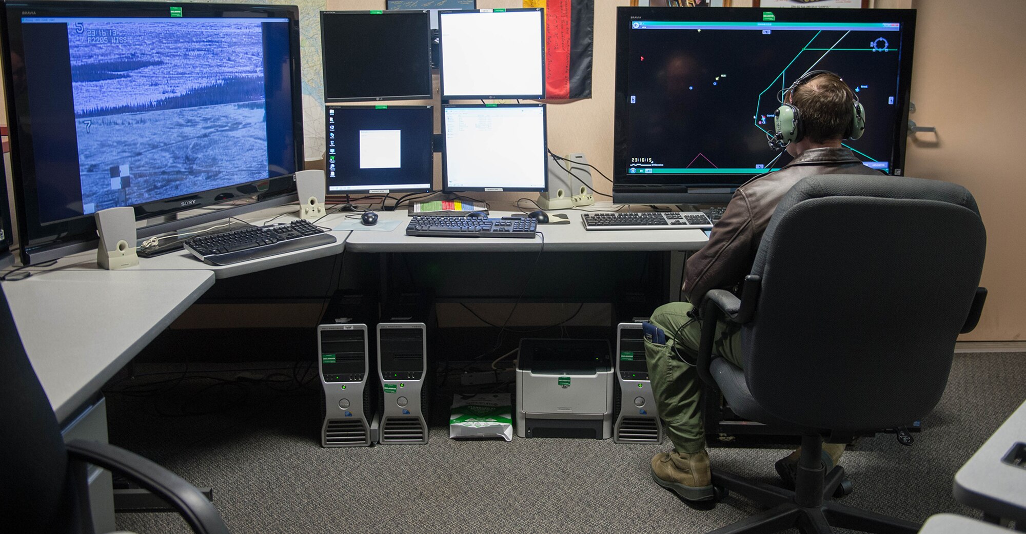 Capt. Matthew Mendenhall, a 353rd Combat Training Squadron baron controller, operates live, virtual and constructive training, April 16, 2015, in preparation for RED FLAG-Alaska 15-2 at Eielson Air Force Base, Alaska. The LVC uses software to integrate virtual cockpits, computer generated forces, live weapons platforms and real life assets fused together to produce a battlefield for training. (U.S. Air Force photo by Staff Sgt. Shawn Nickel/Released) 