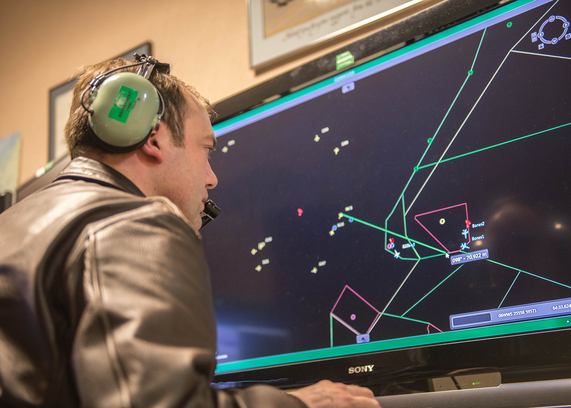 Capt. Matthew Mendenhall, a 353rd Combat Training Squadron baron controller, operates live, virtual and constructive training, April 16, 2015, in preparation for RED FLAG-Alaska 15-2 at Eielson Air Force Base, Alaska. The LVC uses software to integrate virtual cockpits, computer generated forces, live weapons platforms and real life assets fused together to produce a battlefield for training. (U.S. Air Force photo by Staff Sgt. Shawn Nickel/Released) 