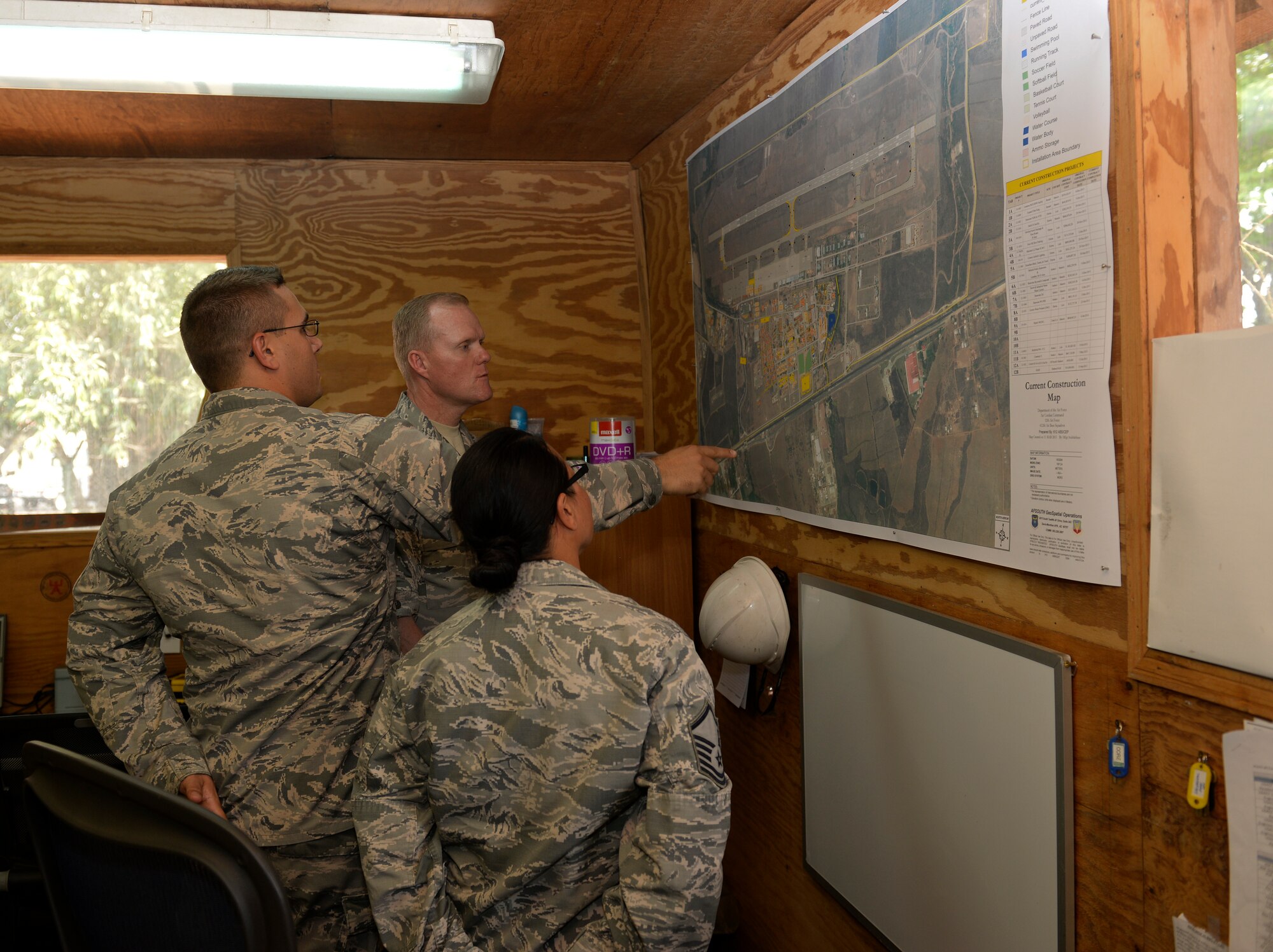 Chief Master Sgt. of the Air Force James A. Cody views future base project plans at the base civil engineer unit April 14, 2015, at Joint Task Force - Bravo, Soto Cano Air Base, Honduras. During his visit, Cody visited BCE as well as several other units throughout Soto Cano AB. (U.S. Air Force photo by Staff Sgt. Jessica Condit)