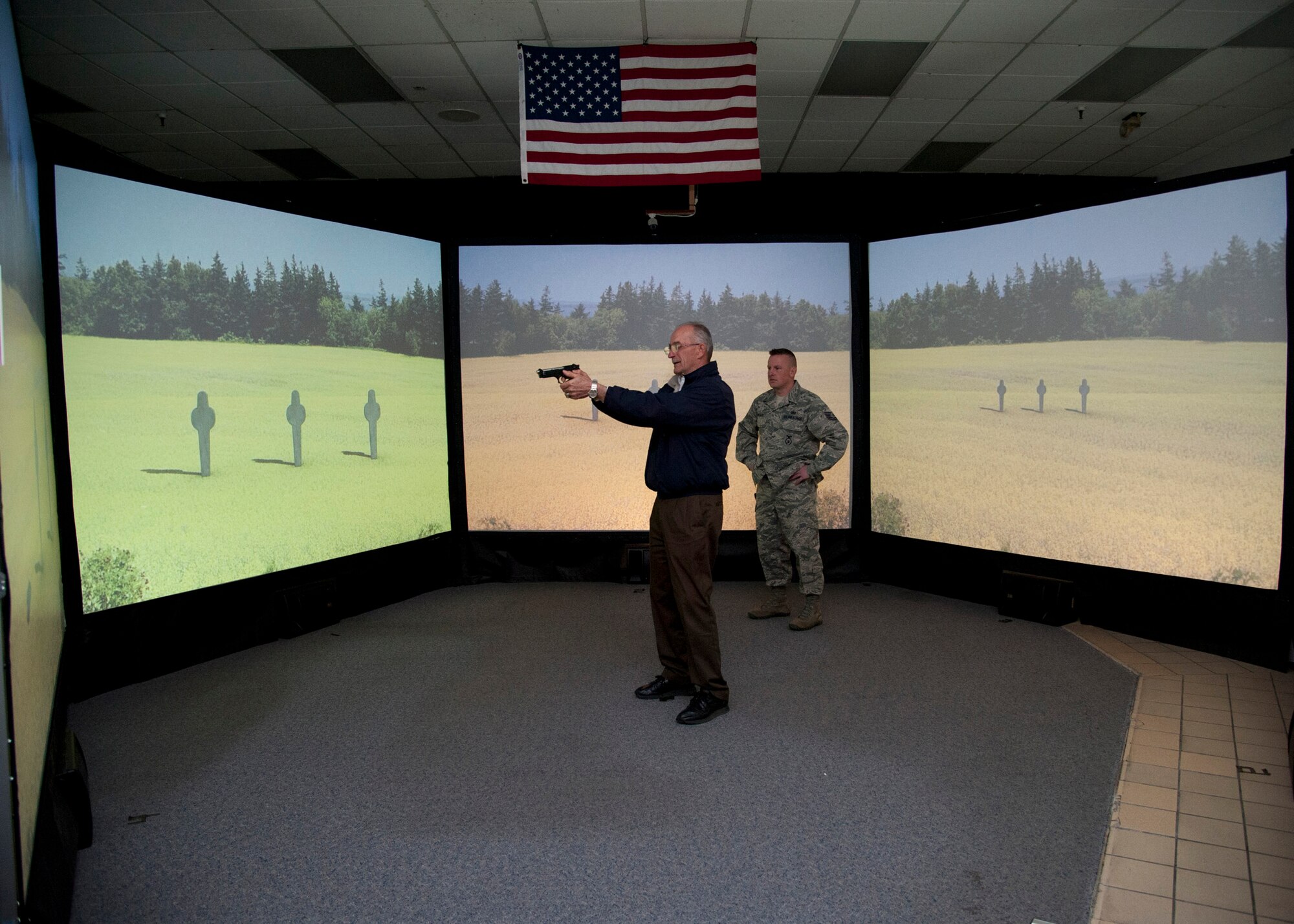 PETERSON AIR FORCE BASE, Colo. – Retired Maj. Gen. Edward Mechenbier tests his firing skills using the 21st Security Forces Squadron virtual program during an American300 tour April 14, 2015. The American300 is a volunteer, non-profit organization which focuses on spending quality time with service members, bringing subject matter experts on resiliency to mentor and embed a sense of hope and understanding of the capabilities people possess in certain situations whether it is in war or on the home front. (U.S. Air Force photo by Senior Airman Tiffany DeNault)
