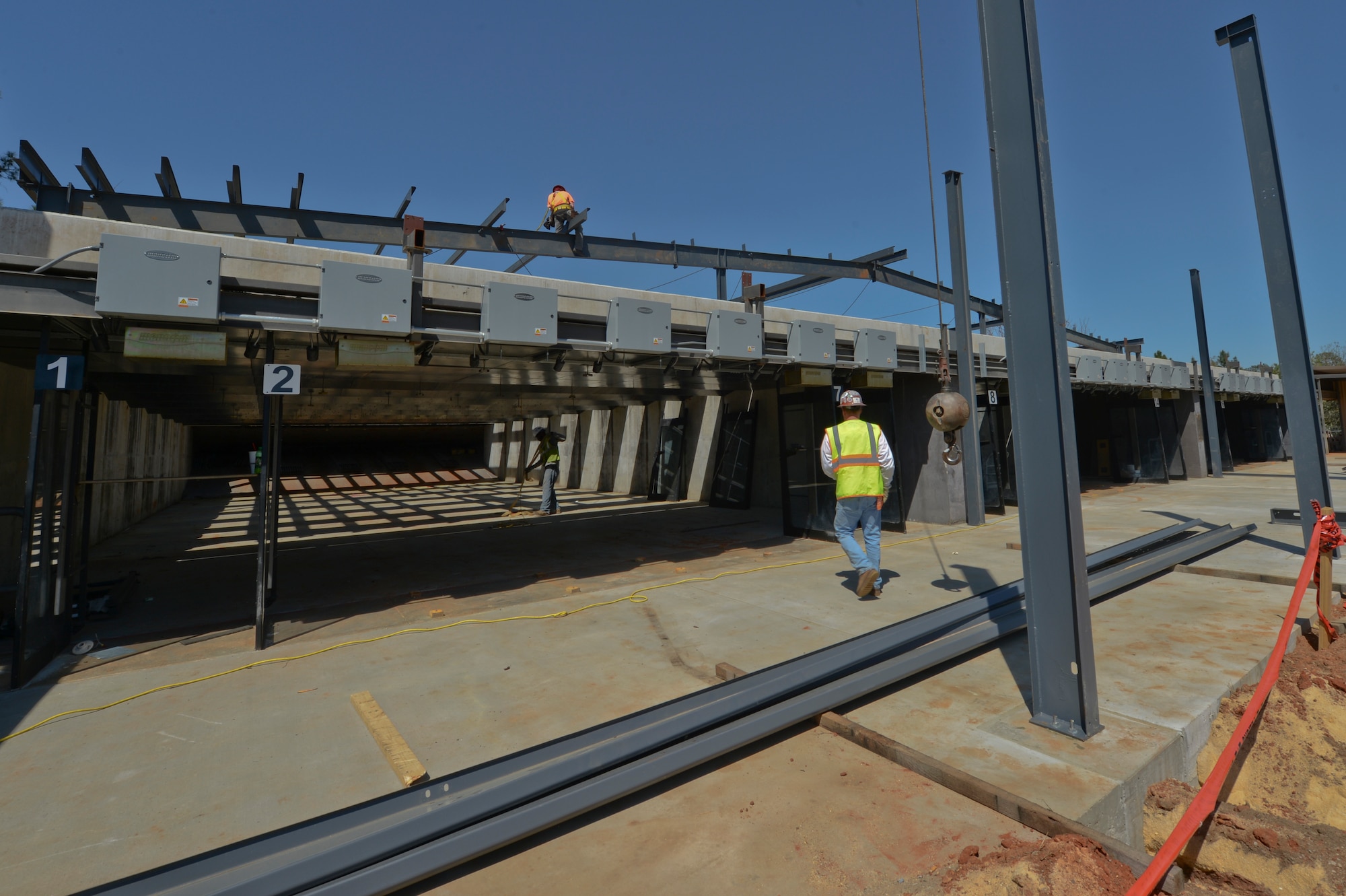 Iron workers work on the structure of the new Combat Arms building at Shaw Air Force Base, S.C., March 31, 2015. The once outdoor Combat Arms range will be an indoor range when finished which is forecasted to be complete by August 2015. (U.S. Air Force photo by Senior Airman Tabatha Zarrella/Released)