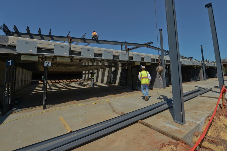 Iron workers work on the structure of the new Combat Arms building at Shaw Air Force Base, S.C., March 31, 2015. The once outdoor Combat Arms range will be an indoor range when finished which is forecasted to be complete by August 2015. (U.S. Air Force photo by Senior Airman Tabatha Zarrella/Released)