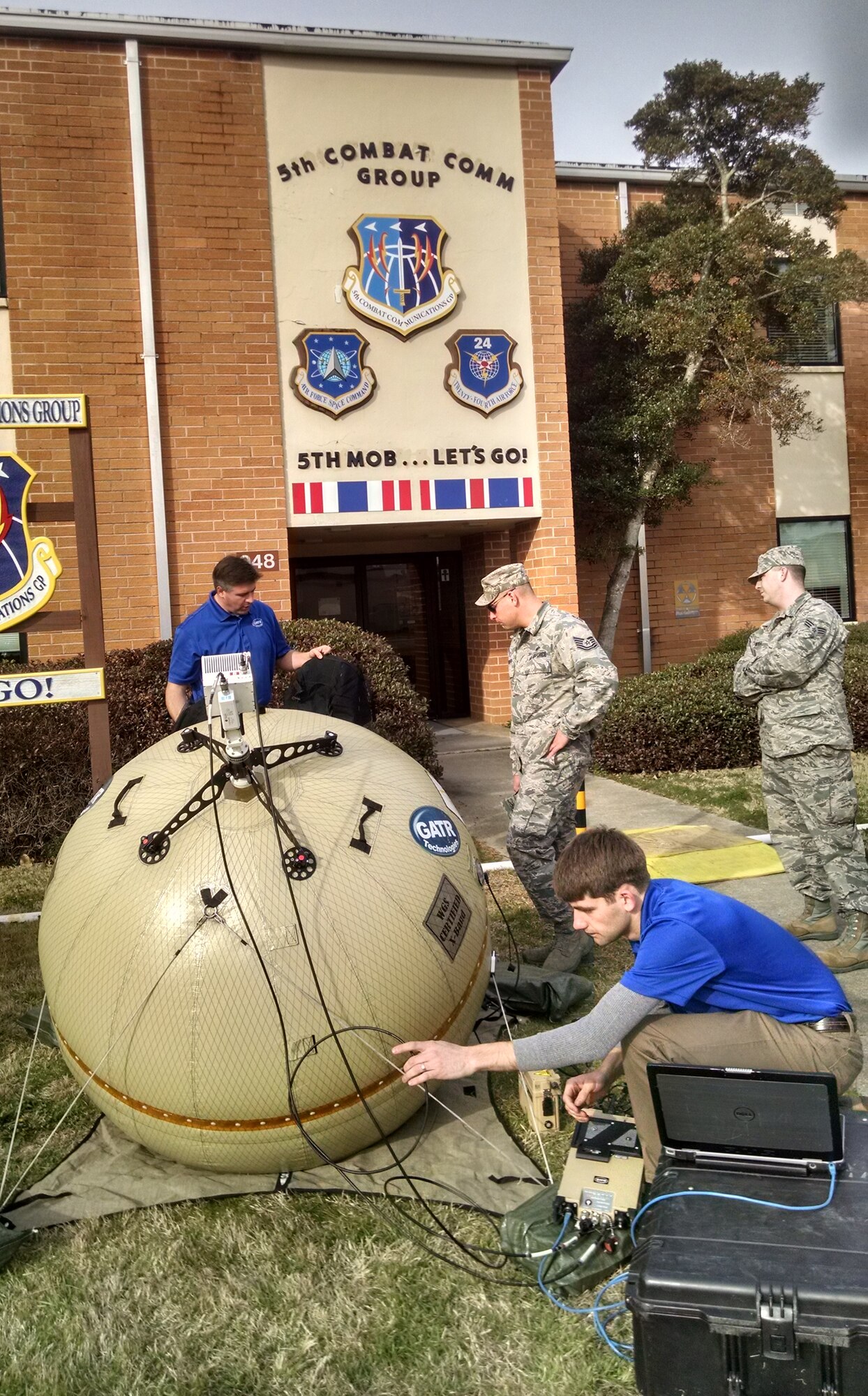 Representatives demonstrate A GATR inflatable satellite communications antenna terminal to members from the 5th Combat Communications Group at Robins Air Force Base, Georgia. (Air Force photo)