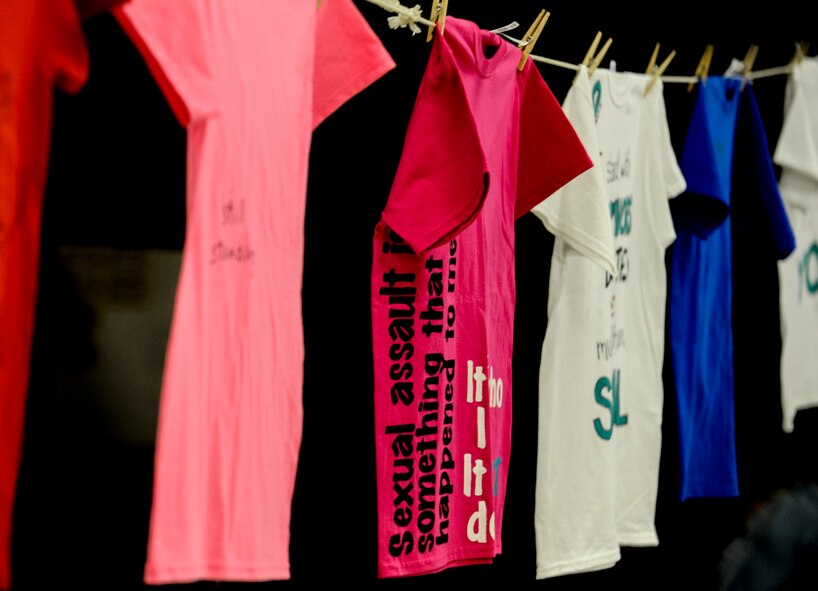 T-shirts hang from a line as part of the Clothesline Project during the Walk a Mile in Her Shoes event on Minot Air Force Base, N.D., April 10, 2015. The Clothesline Project encourages survivors of sexual assault and their supporters to create unique shirts showcasing their messages of strength and resilience. (U.S. Air Force photo/Senior Airman Stephanie Morris)
