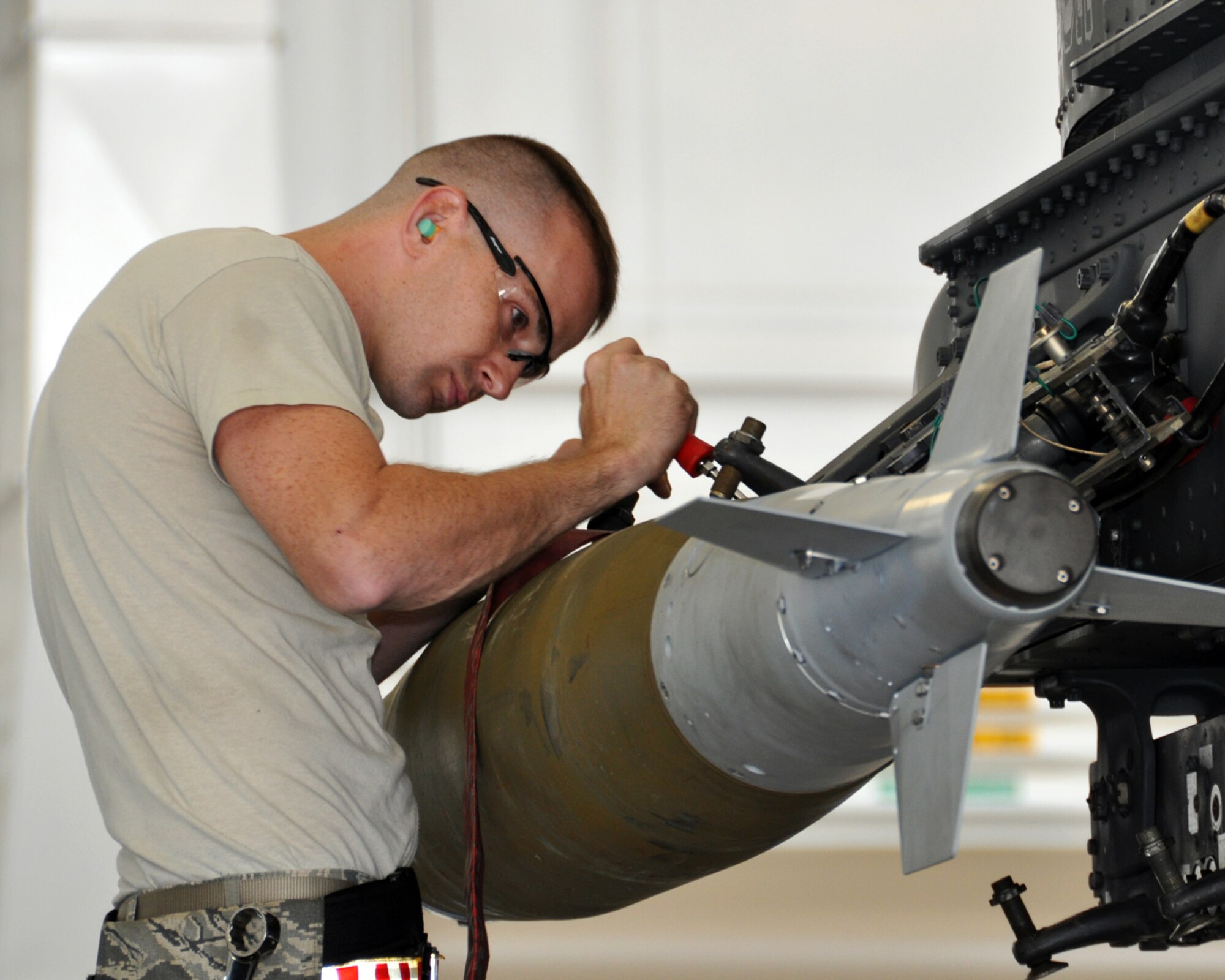 U.S. Air Force Senior Airman Jeremy Pratta, assigned to the 20th Aircraft Maintenance Unit makes adjustments to a bomb rack on a B-52 Stratofortress during the 2nd Aircraft Maintenance Squadron Weapons Load Crew of the Quarter on April 10, 2015 on Barksdale Air Force Base, La. The competition included a dress and appearance inspection, a written test, an inspection of tools and equipment, along with the timed weapons loading technical operation. (U.S. Air Force photo by Master Sgt. Laura Siebert/Released)