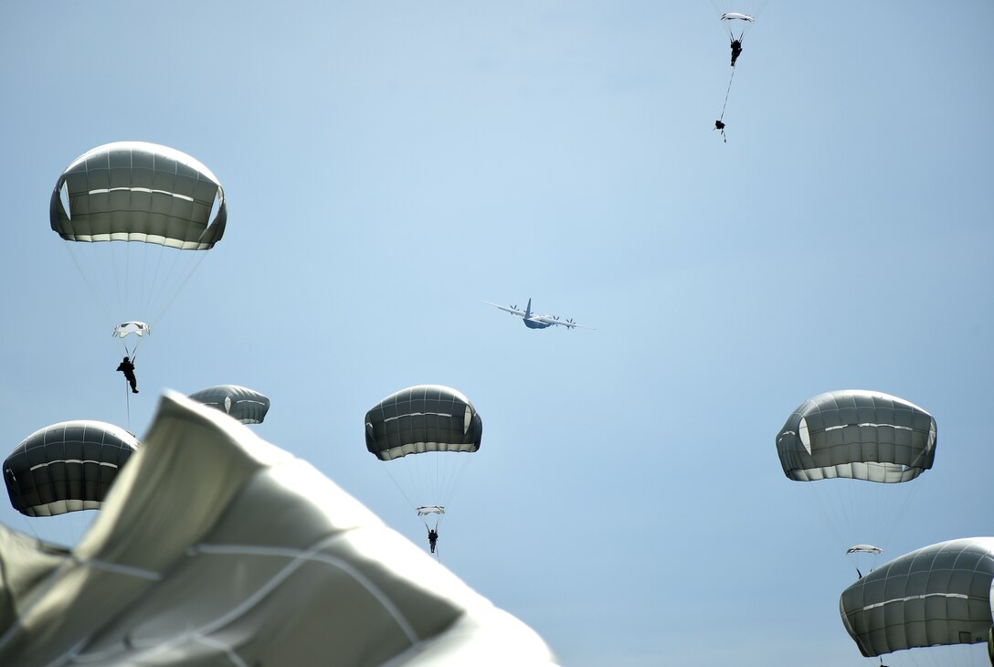 A C-130J Super Hercules assigned to the 317th Airlift Group, Dyess Air Force Base, continues flying after dropping parajumpers from the 82nd Airborne Division, 2nd Brigade Combat Team April 10, 2015, at Fort Bragg, North Carolina. During Combined Joint Operational Access Exercise 15-01, U.S. and British mobility aircraft dropped more than 4,500 parajumpers and thousands of tons of equipment. (U.S. Air Force photo by Senior Airman Peter Thompson/Released)
