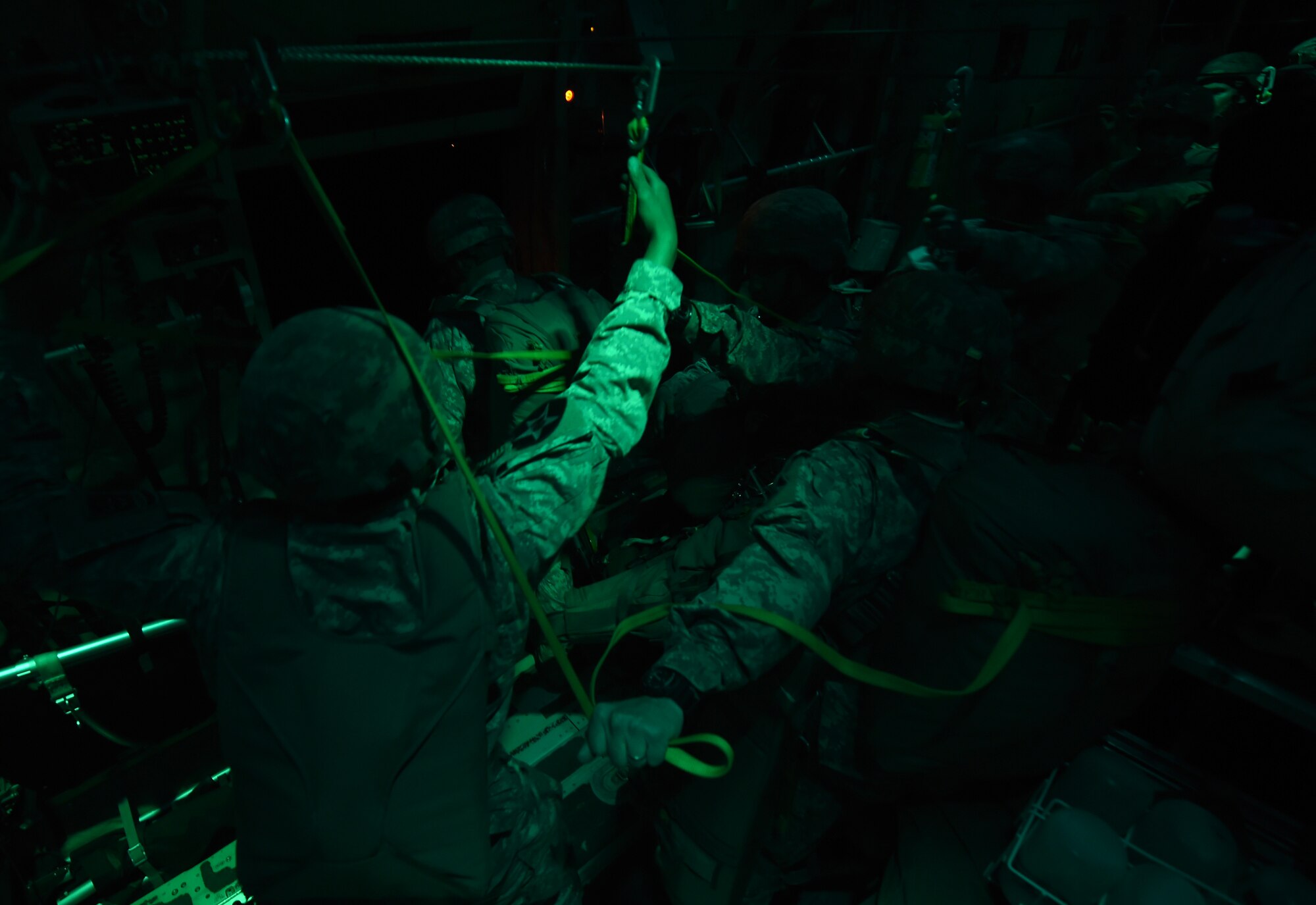 U.S. Army parajumpers from the 1st Brigade Combat Team, 82nd Airborne Division, stand ready for the “green light” April 16, 2015, at Polk Army Airfield, Louisiana. During Combined Joint Operational Access Exercise 15-01, U.S. and British mobility aircraft dropped more than 4,500 parajumpers and thousands of tons of equipment during day and night operations. (U.S. Air Force photo by Senior Airman Peter Thompson/Released)
