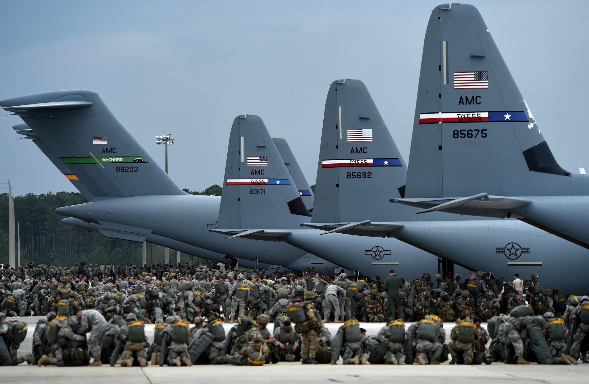 U.S. Army parajumpers from the 82nd Airborne Division and British Army parajumpers from the 16th Air Assault Brigade load onto mobility aircraft during Combined Joint Operational Access Exercise 15-01 April 13, 2015, at Pope Army Airfield, Fort Bragg, North Carolina. CJOAX takes place several times each year to certify the Air Force and Army’s ability to deploy strategic airlift, contingency and support forces in a large formation airdrop.(U.S. Air Force photo by Senior Airman Peter Thompson/Released)