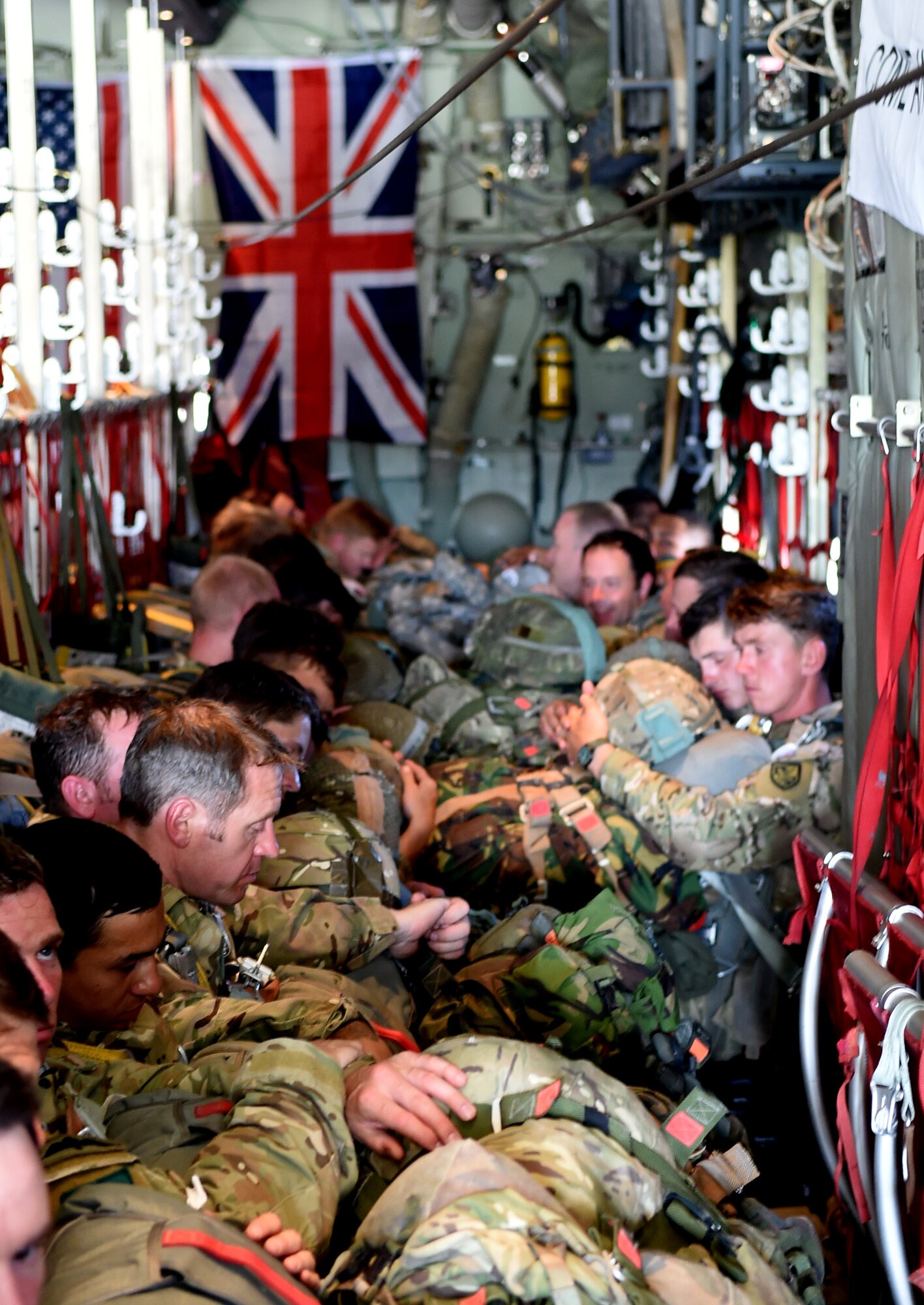 British Army parajumpers from the 16th Air Assault Brigade and U.S. Army parajumpers from the 82nd Airborne Division, 2nd Brigade Combat Team, await takeoff in C-130J Super Hercules assigned to the 317th Airlift Group April 11, 2015, at Pope Army Airfield, Fort Bragg, North Carolina. During Combined Joint Operational Access Exercise 15-01, the British Royal Air Force 47th Squadron and British Army 16th Air Assault Brigade worked side-by-side with American forces to integrate multinational interoperability into the exercise. (U.S. Air Force photo by Senior Airman Peter Thompson/Released)