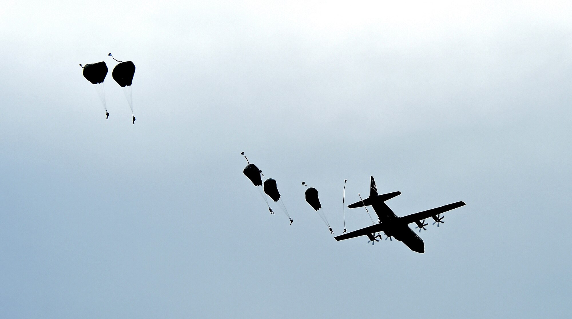 A C-130J Super Hercules assigned to the 317th Airlift Group, Dyess Air Force Base, Texas, airdrops parajumpers from the 82nd Airborne Division, 2nd Brigade Combat Team April 10, 2015, at Fort Bragg, North Carolina. On “hit night” for Combined Joint Operational Access Exercise 15-01, U.S. Air Force and British Royal Air Force aircraft dropped 2,100 parajumpers from the 82nd Airborne Division and British Army 16th Air Assault Brigade. Together, the forces seized a drop zone, which was under simulated enemy control. (U.S. Air Force photo by Senior Airman Peter Thompson/Released)