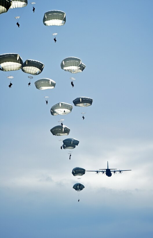 A C-130J Super Hercules assigned to the 317th Airlift Group, Dyess Air Force Base, Texas, airdrops parajumpers from the 82nd Airborne Division, 2nd Brigade Combat Team April 10, 2015, at Fort Bragg, North Carolina. During Combined Joint Operational Access Exercise 15-01, U.S. and British mobility aircraft dropped more than 4,500 parajumpers and thousands of tons of equipment. (U.S. Air Force photo by Senior Airman Peter Thompson/Released)