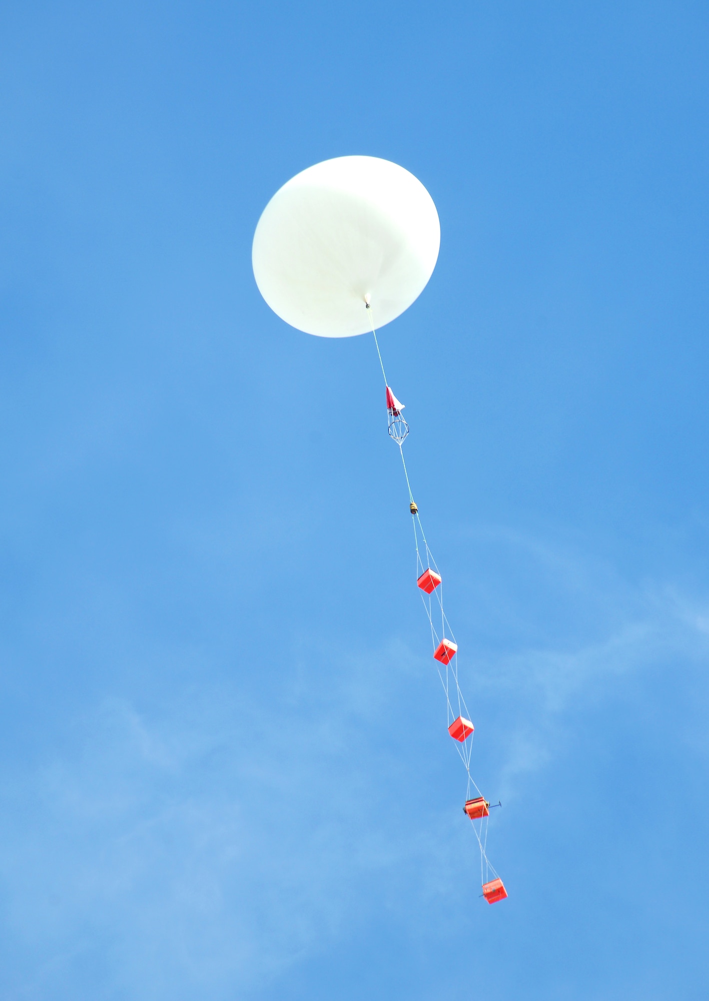 A weather balloon carrying five sensor packages ascends into the air after launch from the Peter Kiewit Institute at the University of Nebraska at Omaha campus April 14, 2015. The launch was part of a project sponsored by NASA called Project HALON, which stands for High Altitude Learning over Nebraska. (U.S. Air Force photo by Delanie Stafford/Released)