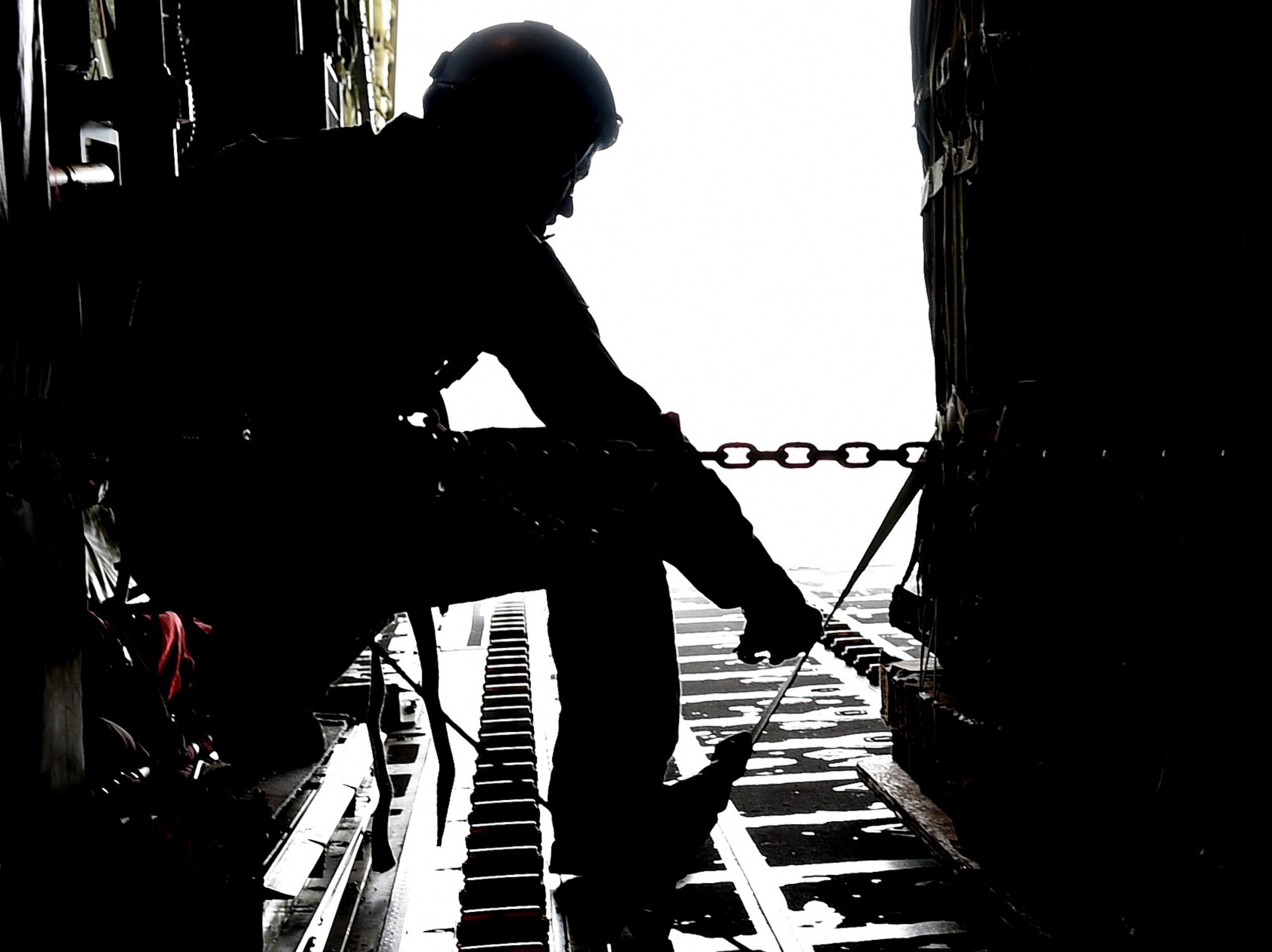 Senior Airman Nicholas McGuire, 40th Airlift Squadron loadmaster, stationed at Dyess Air Force Base, Texas, releases an equipment bundle from a C-130J Super Hercules April 8, 2015, at Fort Bragg, North Carolina. During the days leading up to Combined Joint Operational Access Exercise 15-01, maintainers and aircrew had opportunities to work with U.S. Army and British Royal Air Force personnel to fine-tune processes and procedures across aircraft platforms. (U.S. Air Force photo by Senior Airman Peter Thompson/Released)