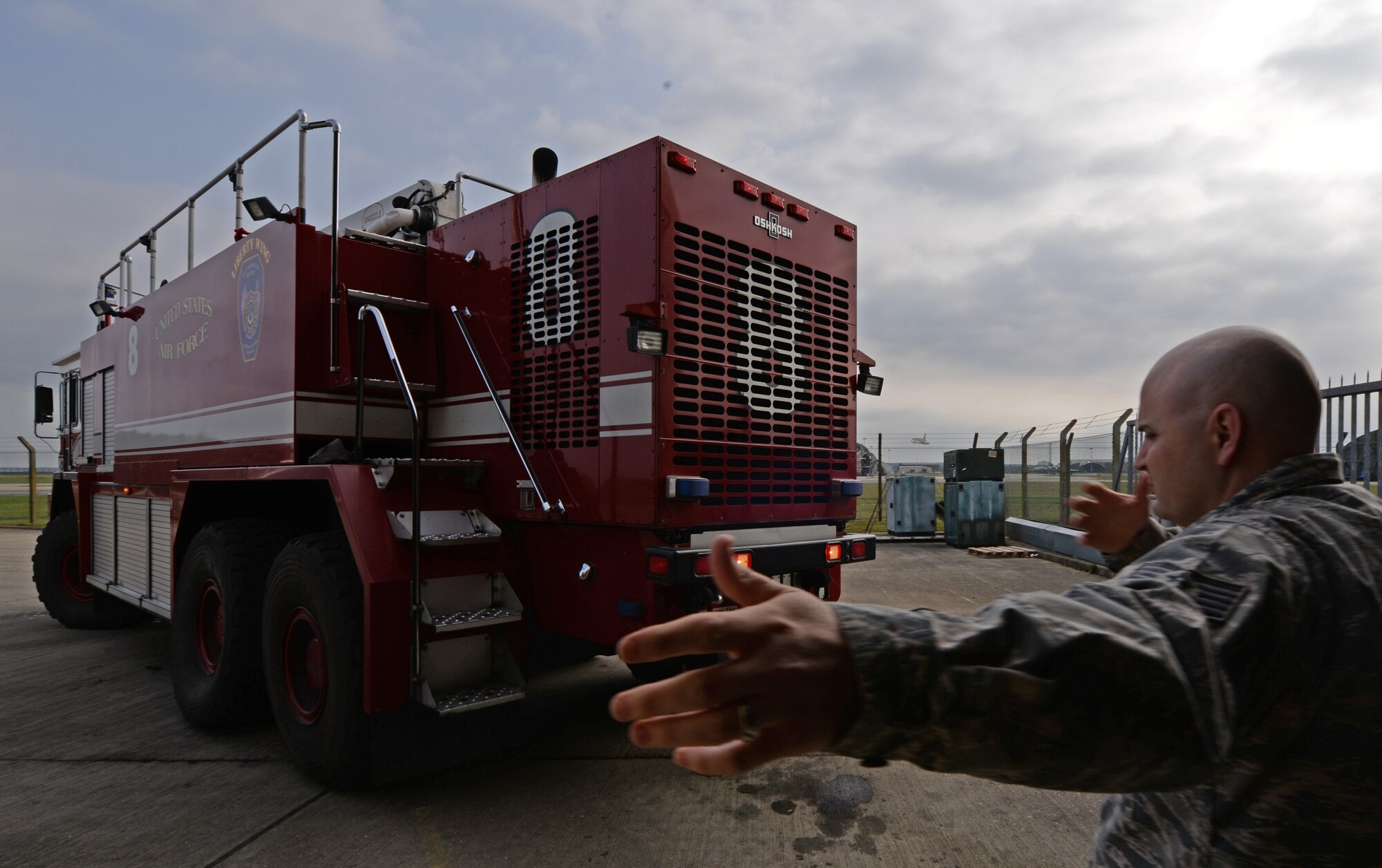 Tech. Sgt. Kevin Coughlin, 48th Civil Engineer Squadron fire station captain, guides a crash fire truck as it backs into the station stall at Royal Air Force Lakenheath, England, April 8, 2015. The truck was prepositioned to ensure the readiness of the firefighters to respond to emergencies. (U.S. Air Force photo by Airman 1st Class Erin R. Babis/Released)