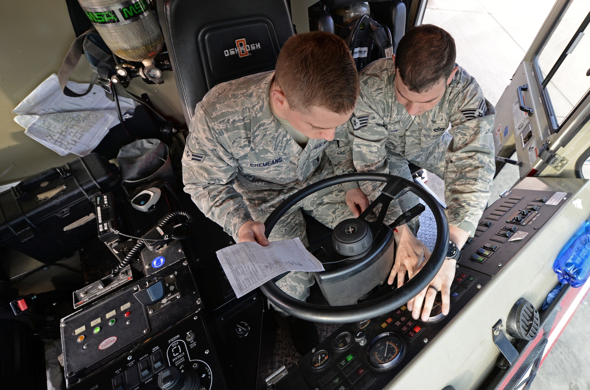Airman 1st Class Kyle Cremeans, 48th Civil Engineer Squadron firefighter, and Staff Sgt. Tyler McLain, 48th CES fire crew chief, perform a daily operational check on a fire truck at Royal Air Force Lakenheath, England, April 8, 2015. The equipment check ensures the readiness of the firefighters to respond to emergencies. (U.S. Air Force photo by Airman 1st Class Erin R. Babis/Released)