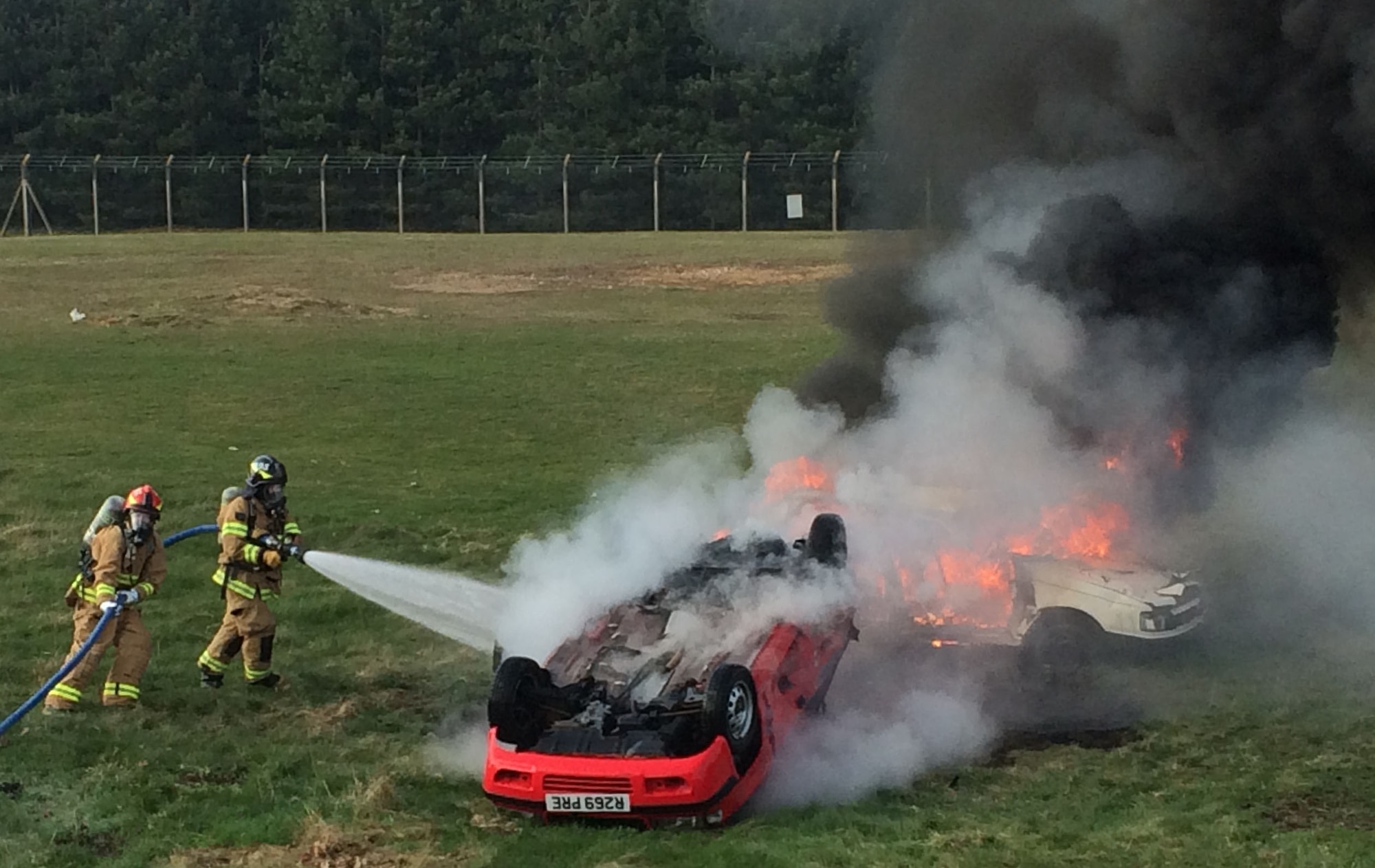 Firefighters with the 48th Civil Engineer Squadron put out a fire during a training exercise at Royal Air Force Lakenheath, England, April 9, 2015. Firefighters spent time training while on shift to ensure they knew where equipment was located on the truck and how to effectively use it. (U.S. Air Force photo by Airman 1st Class Zackery Newton/Released)