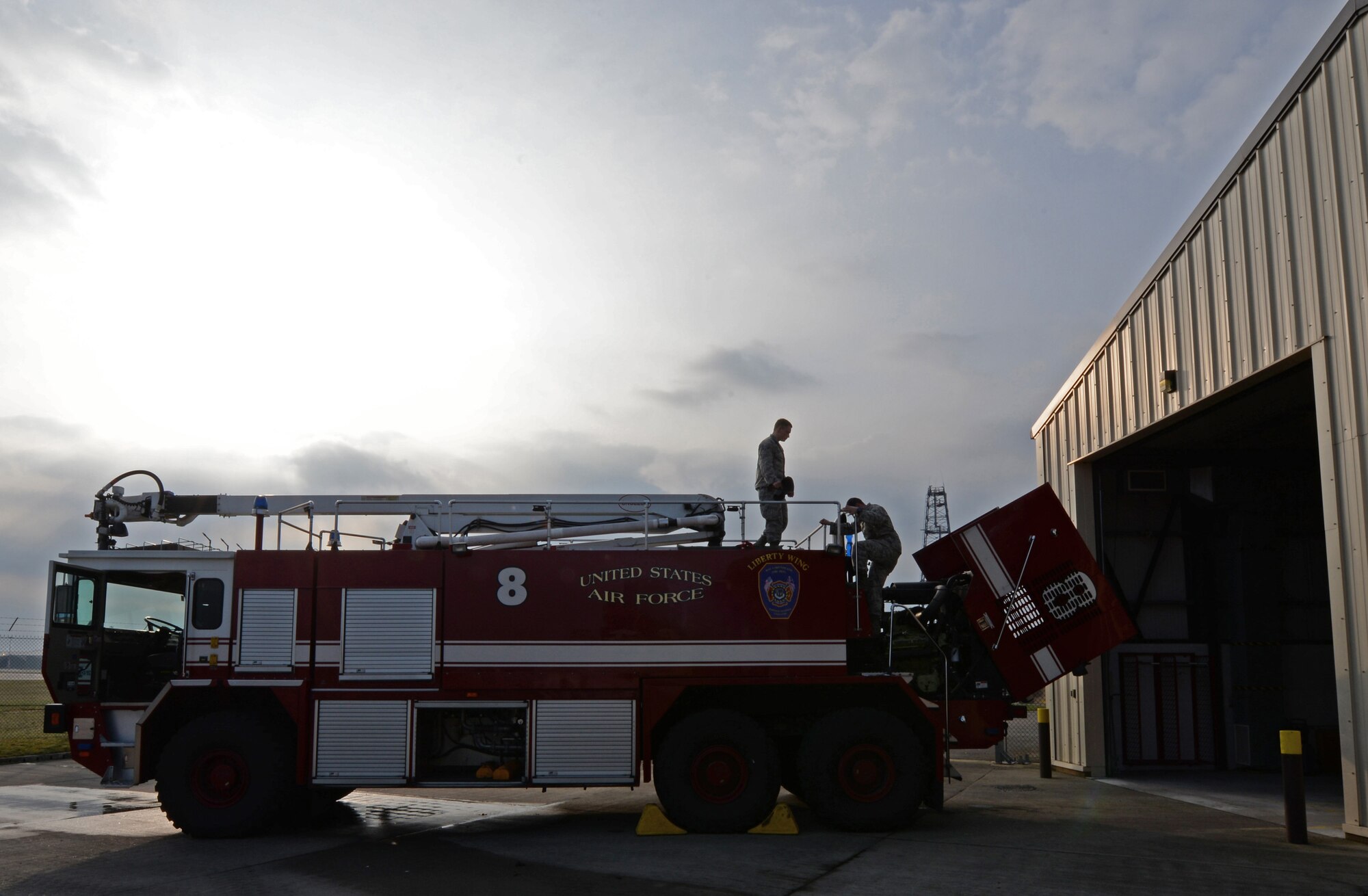 Airman 1st Class Kyle Cremeans, 48th Civil Engineer Squadron firefighter, and Staff Sgt. Tyler McLain, 48th CES fire crew chief, perform a daily operational check on a crash fire truck at Royal Air Force Lakenheath, England, April 8, 2015. Firefighters spent time training while on shift to ensure they knew where equipment was located on the truck and how to effectively use it. (U.S. Air Force photo by Airman 1st Class Erin R. Babis/Released)