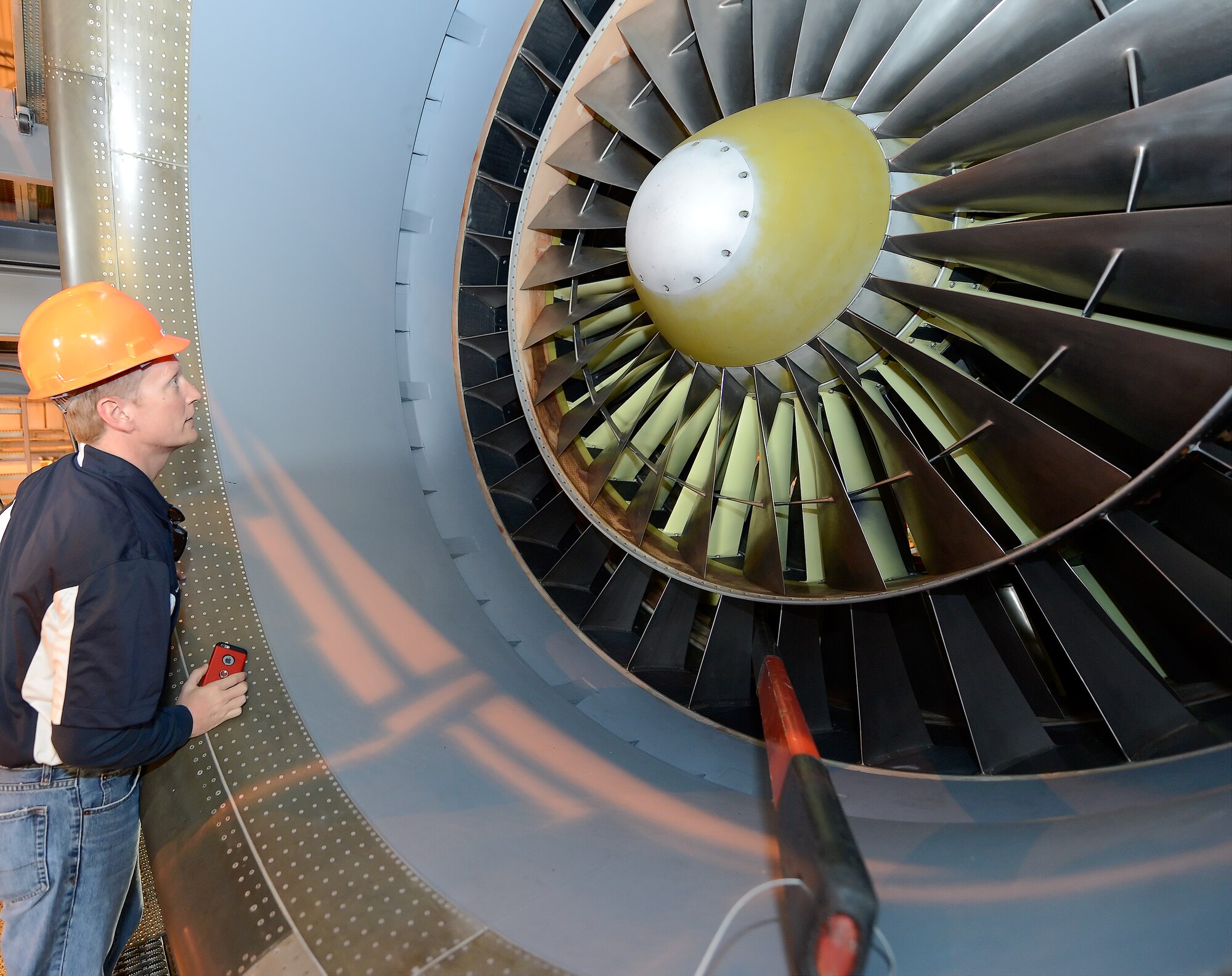 Andrew Johnson, 512th Maintenance Squadron honorary commander, looks in to the engine inlet of a TF-39 jet engine hanging under the wing of a C-5B Galaxy of the 439th Airlift Wing, Air Force Reserve Command, during the 2015 Dover Air Force Base Honorary Commanders during a tour of the 436th Maintenance Group April 15, 2015, on Dover AFB, Del. Team Dover performs heavy isochronal maintenance for the entire fleet of active-duty, Guard and Reserve C-5s. (U.S. Air Force photo/Greg L. Davis)