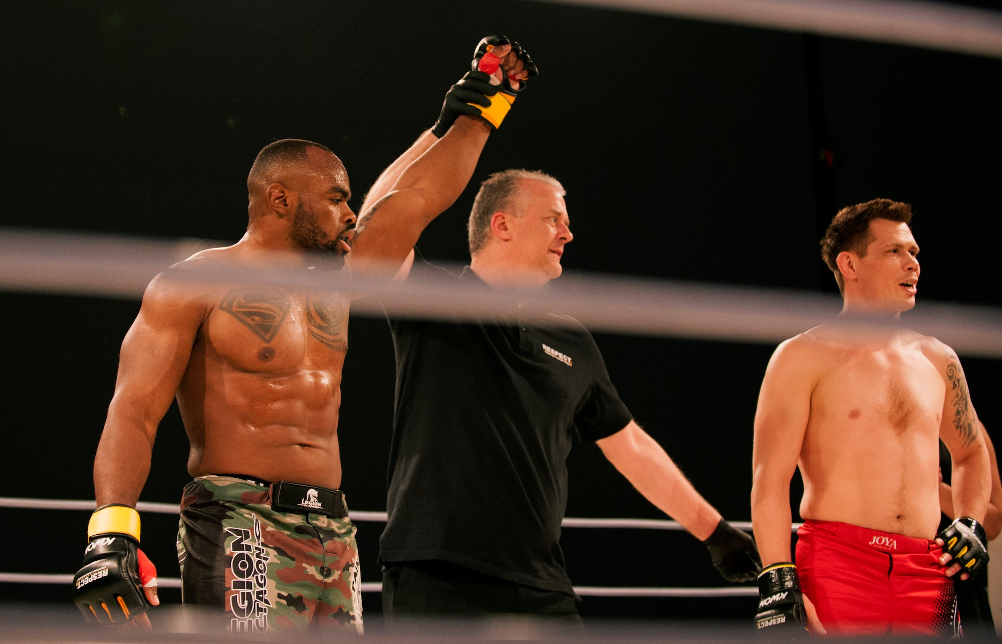 U.S. Air Force Tech. Sgt. Clinton Williams, 52nd Component Maintenance Squadron engine manager, left, raises his hand after he is pronounced the victor during the 12th Kwon Respect Fighting Championship in Wuppertal, Germany, April 11, 2015. The fight sealed William’s second victory out of two fights in Germany and his 11th overall victory out of 12 fights in his mixed martial arts career. (U.S. Air Force photo by Airman 1st Class Timothy Kim/Released)