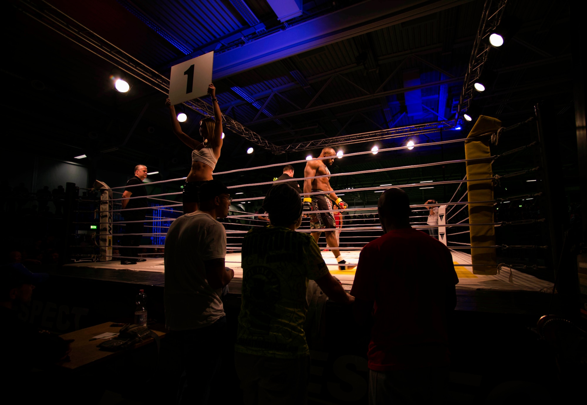 U.S. Air Force Tech. Sgt. Clinton Williams, 52nd Component Maintenance Squadron engine manager, walks to his corner in the fighting arena during the 12th Kwon Respect Fighting Championship in Wuppertal, Germany, April 11, 2015. Williams fought in the ninth match of 13 fights that night and faced off against Raymond Jarman, a mixed martial artist from Amsterdam. (U.S. Air Force photo by Airman 1st Class Timothy Kim/Released)