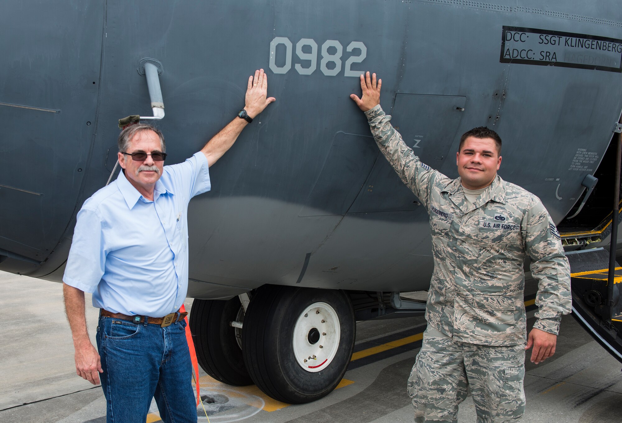 Retired U.S. Air Force Senior Master Sgt. Lawrence Herter, former crew chief and Staff Sgt. Kenzi Klingenberg, 723d Aircraft Maintenance Squadron crew chief, pose for a photo April 15, 2015, at Moody Air Force Base, Ga. Herter traveled to Moody to see the aircraft one last time before its retirement later this year. (U.S. Air Force photo by Airman 1st Class Ceaira Tinsley/Released)