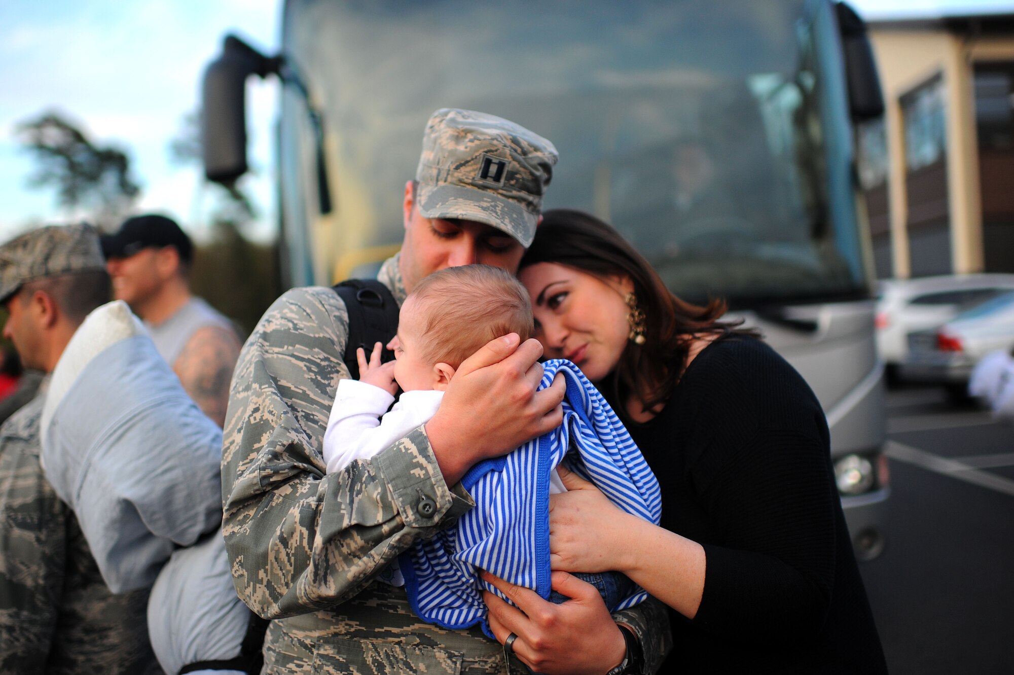 An Airman from the 606th Air Control Squadron meets his son for the first time at a deployment homecoming on Spangdahlem Air Base, Germany, April 17, 2015. The family surprised the Airman because he thought they would arrive in Germany the next day. (U.S. Air Force photo by Senior Airman Gustavo Castillo/Released) 