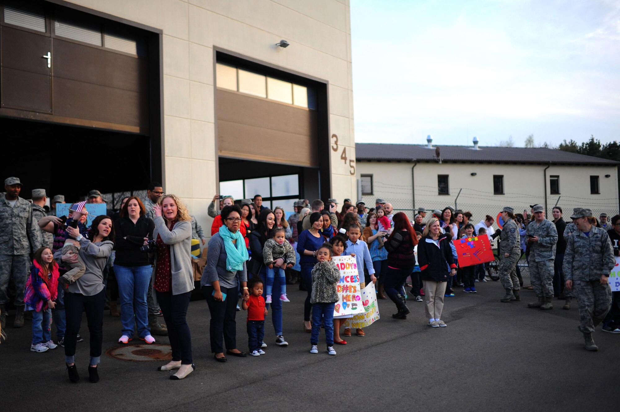 Families and friends from the 606th Air Control Squadron wait for deployed members to return during a homecoming on Spangdahlem Air Base, Germany, April 17, 2015. This was the largest of several waves of 606th returnees from deployed locations in South East Asia. (U.S. Air Force photo by Senior Airman Gustavo Castillo/Released) 