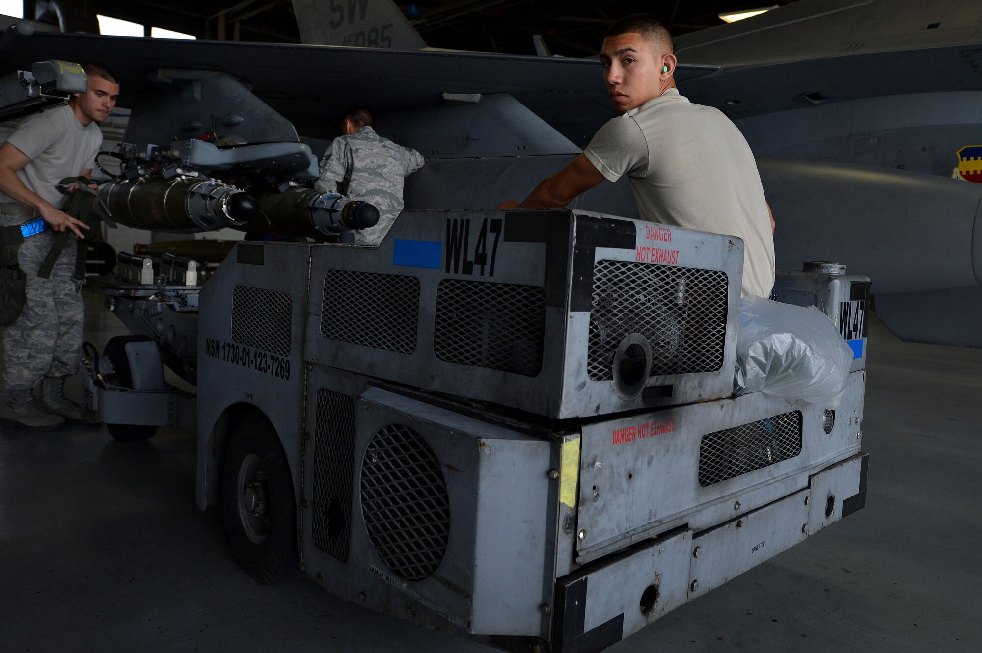 U.S. Air Force Airman 1st Class Rosendo Avalos, 20th Aircraft Maintenace Squadron weapons technician, looks back before reversing a bomb loader during a load crew of the year competition at Shaw Air Force Base, S.C., April 17, 2015. The load crew competition enhances Airmen’s skills while operating under pressure. (U.S. Air Force photo by Airman 1st Class Michael Cossaboom/Released)