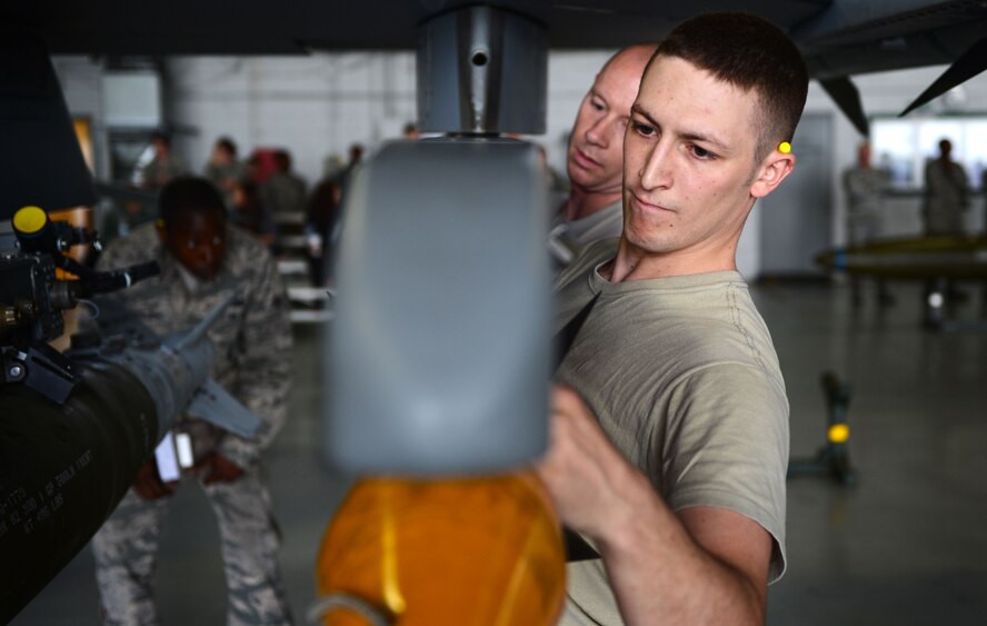 U.S. Air Force Senior Airman Ricky Hamrick, 20th Equipment Maintenance Squadron load crew member, loads an AIM-9X missile onto an F-16CM Fighting Falcon during a load crew of the year competition at Shaw Air Force Base, S.C., April 17, 2015. Hamrick and his team competed against three teams to earn the title of load crew of the year. (U.S. Air Force photo by Senior Airman Jensen Stidham/Released)