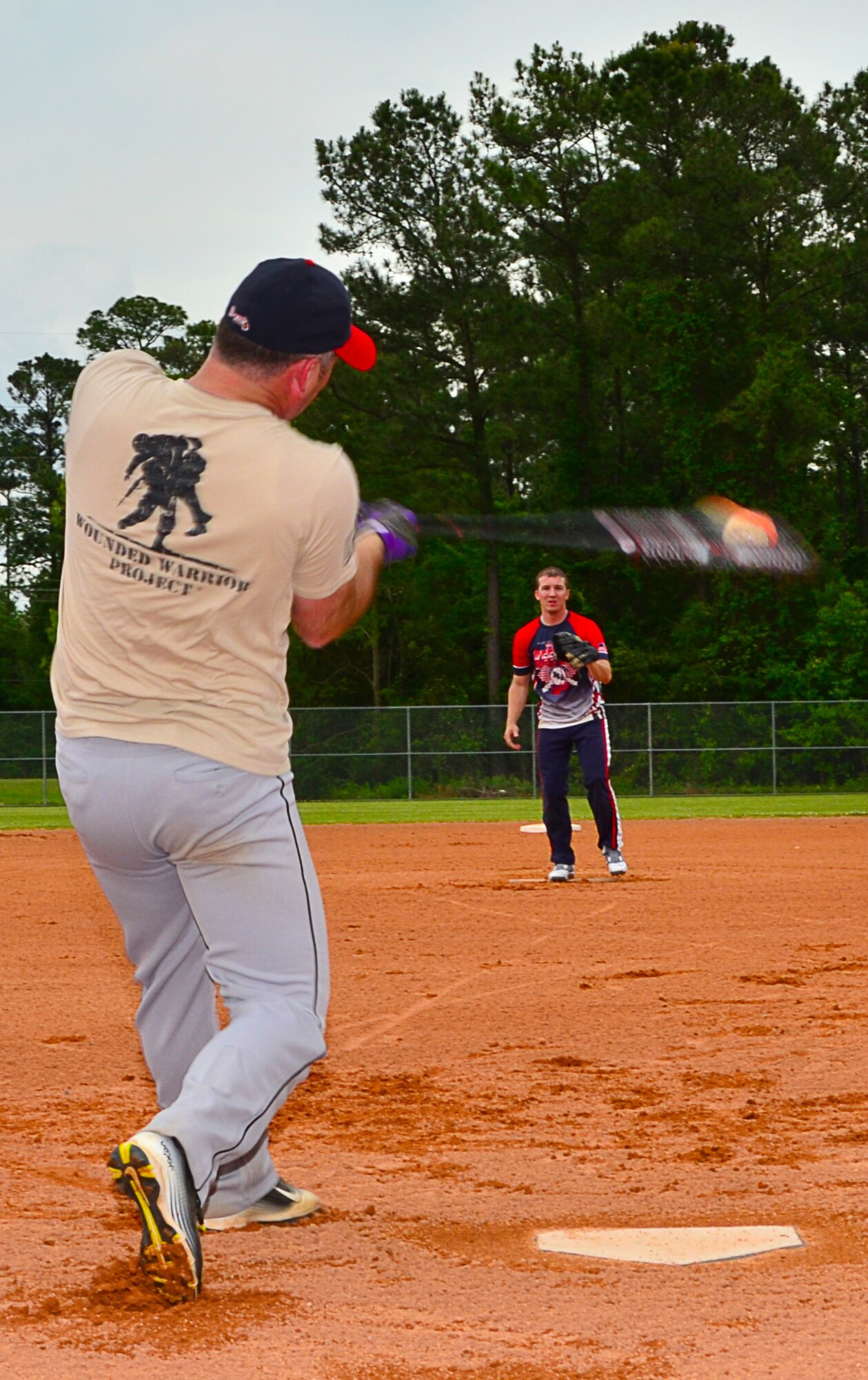 Staff Sgt. Ernest Scruggs, a Com/Nav technician with the 403rd Maintenance Group pitches to Tech Sgt. Robert Register a 403rd Maintenance Group crew chief during a pickup softball game to relieve stress at the end of the day on the Saturday of the April Unit Training Assembly. (U.S. Air Force Photo/Master Sgt. Brian Lamar.)