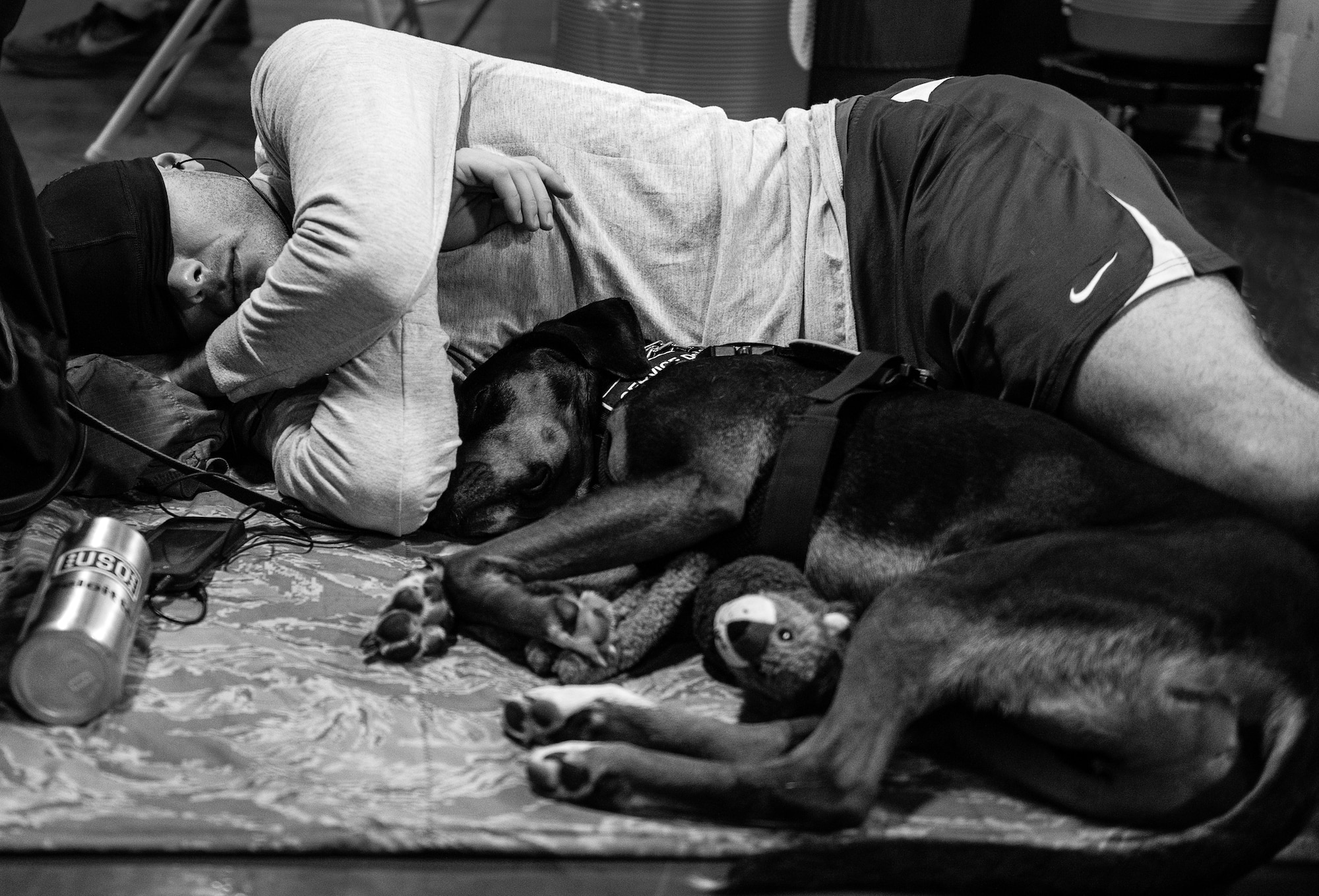 Air Force Wounded Warrior athlete, Ryan Largeman, and his service dog, Duke, curl up together for a short nap during the second day of the Warrior Games training camp at Eglin Air Force Base, Fla., April 19. The five-day training camp for the Air Force’s athletes serves as their last practice session before the Warrior Games June 19-28. (U.S. Air Force photo/Samuel King Jr.)