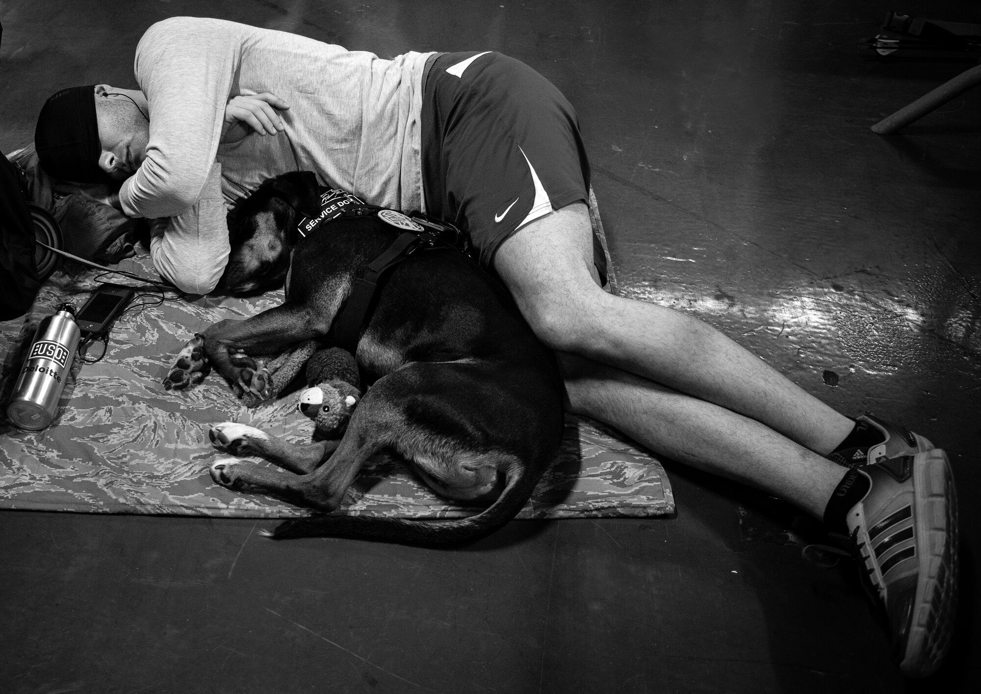 Air Force Wounded Warrior athlete, Ryan Largeman, and his service dog, Duke, curl up together for a short nap during the second day of the Warrior Games training camp at Eglin Air Force Base, Fla., April 19. The five-day training camp for the Air Force’s athletes serves as their last practice session before the Warrior Games June 19-28. (U.S. Air Force photo/Samuel King Jr.)