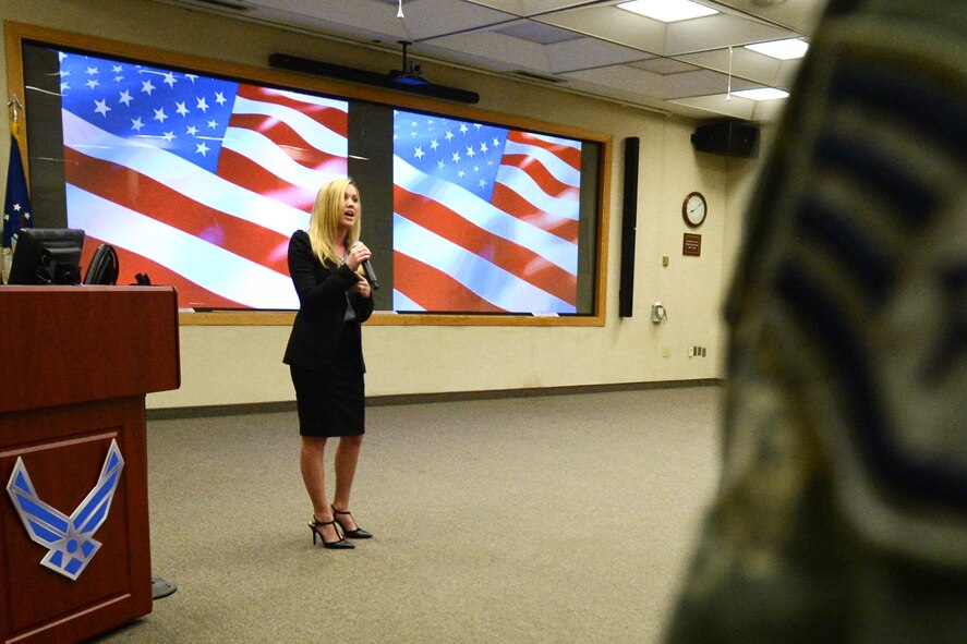 Jamie Poe, 66th Force Support Squadron administrative assistant, sings the national anthem at the beginning of the 66th Air Base Group Quarterly Awards ceremony at the Hanscom Conference Center April 17. The air base group named their first quarter award winners during the ceremony. (U.S. Air Force photo by Jerry Saslav)