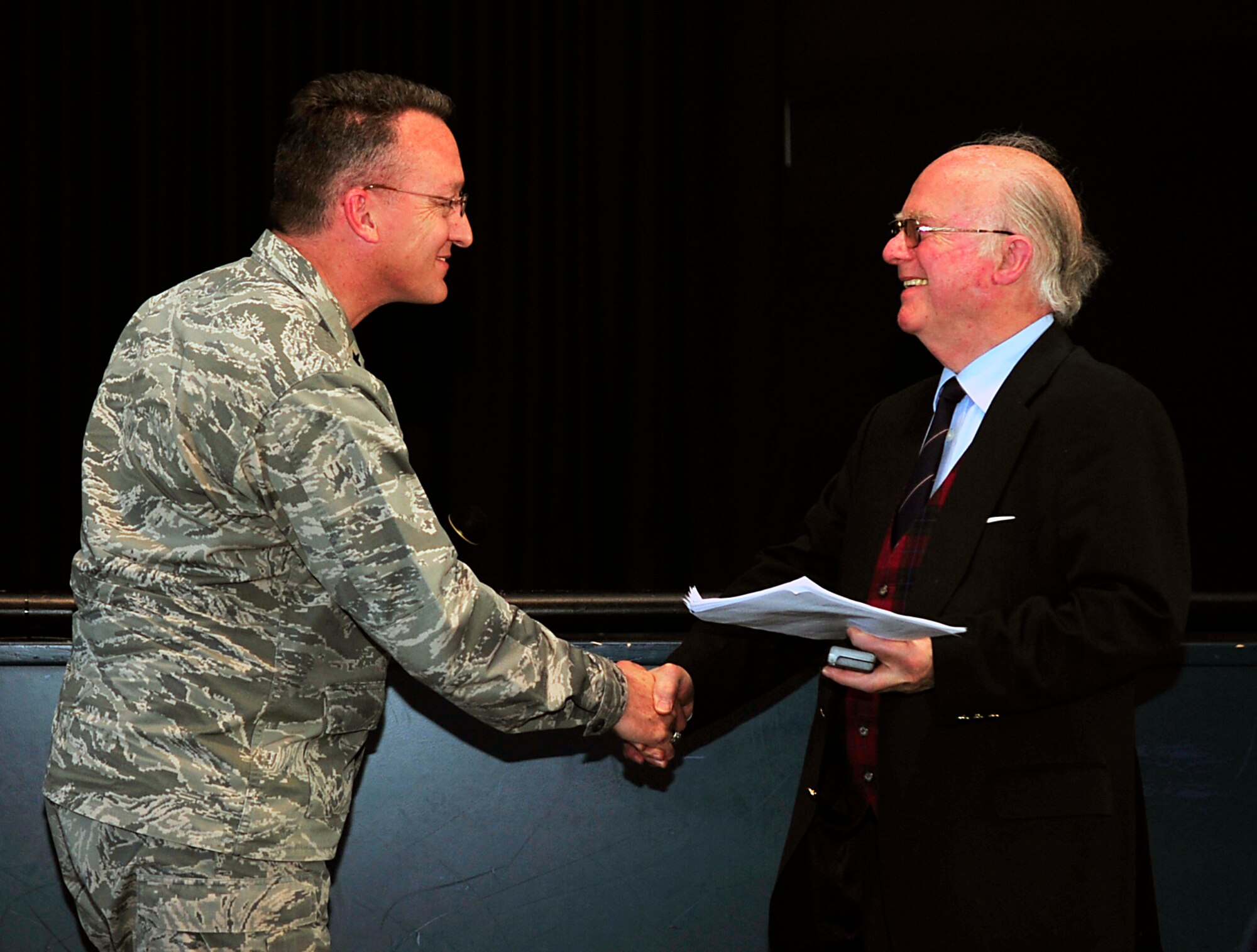 Brig. Gen. Patrick Mordente, 86th Airlift Wing commander, shakes hands with Friedrich Wilhelm von Hase, son of German army Lt. Gen. Paul von Hase, during a Holocaust Remembrance Day ceremony April 15, 2015, at Ramstein Air Base, Germany. Von Hase reminded the Kaiserslautern Military Community members about the struggles and suffering victims experienced during the Holocaust. (U.S. Air Force photo/Airman 1st Class Larissa Greatwood)