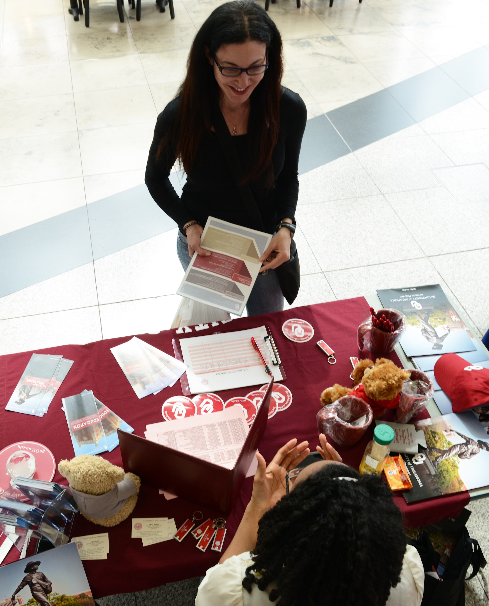 Gabriella Wells, military spouse, asks questions about education programs at the University of Oklahoma table at the 86th Force Support Squadron Ramstein Education Center Education Fair, April 16, 2015 at Ramstein Air Base, Germany. The purpose of the fair was to provide information about all the education programs offered at Ramstein. (U.S. Air Force photo/Airman 1st Class Tryphena Mayhugh)