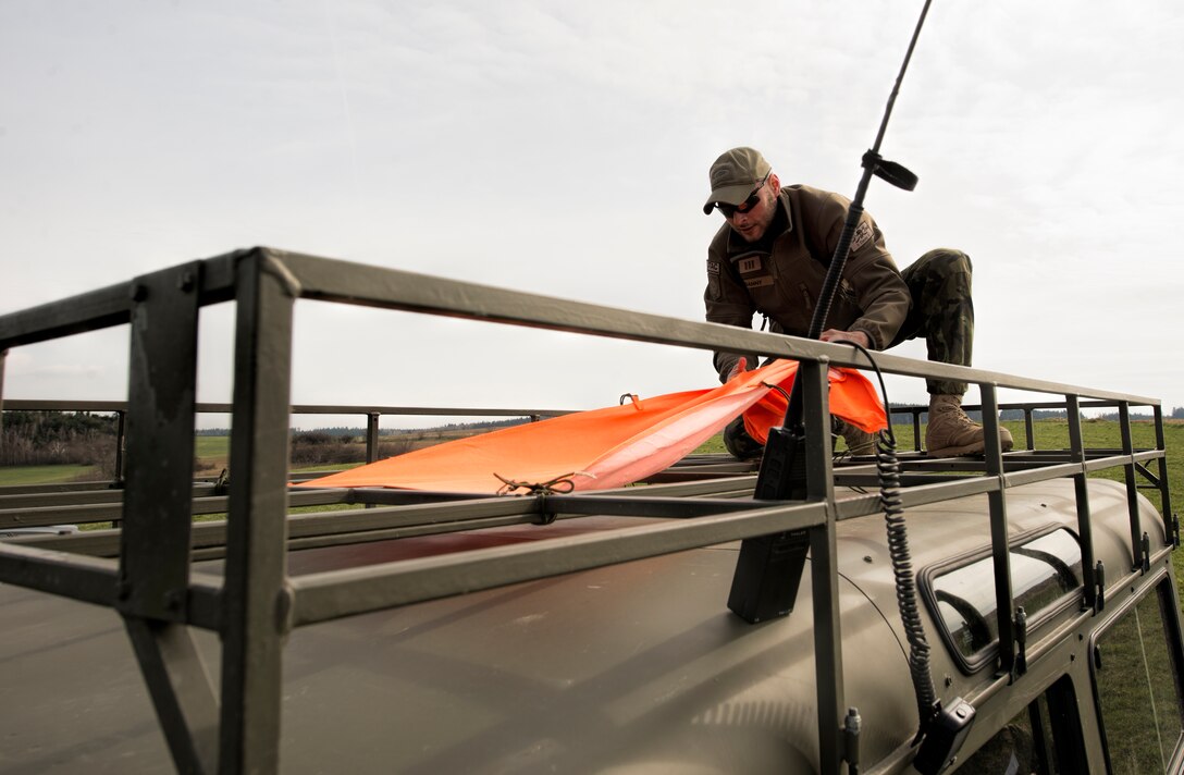 A Czech Republic air force joint terminal attack controller secures a marker on a vehicle during a theater security package deployment at Namest Air Base, Czech Republic, April 14, 2015. To reduce the risk of friendly fire, the marker indicates the vehicle is part of the friendly operating forces. The 354th Expeditionary Fighter Squadron forward deployed from 355th Fighter Wing, Davis-Monthan Air Force Base, Ariz., in the first of several deployments of rotational forces to the European region.  (U.S. Air Force photo by Staff Sgt. Christopher Ruano/Released) 