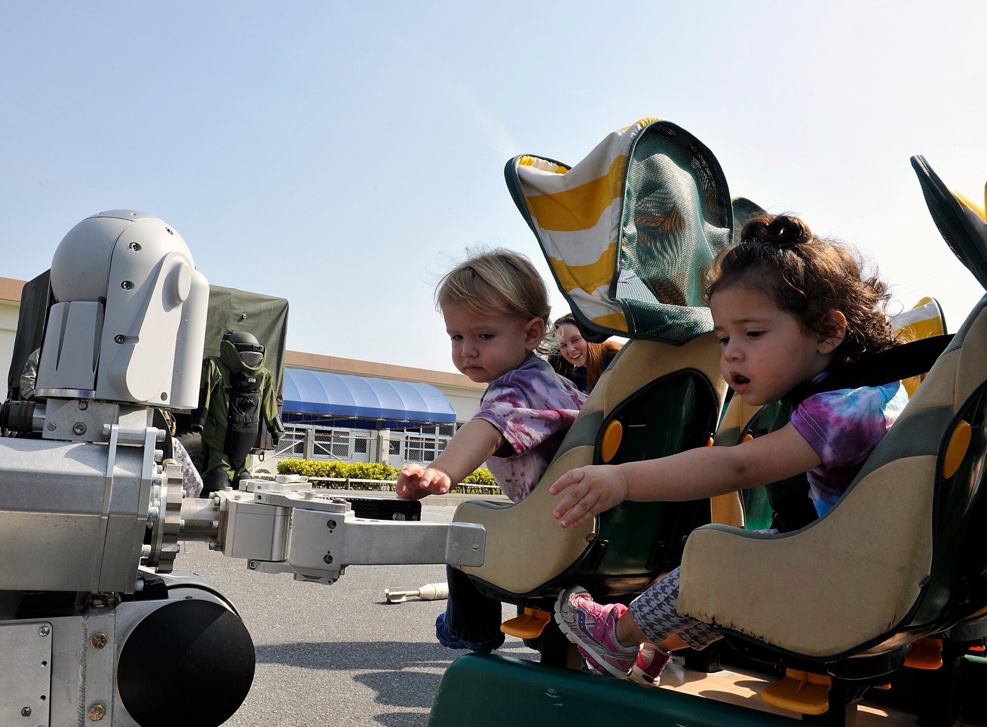 Children from the Niko-Niko Child Development Center touch an arm of an explosive ordnance disposal robot during a Military Child Appreciation Month showcase on Kadena Air Base, Japan, April 17, 2015. The Unites States Armed Forces recognizes April as the Month of the Military Child. This special time of year is a chance to show appreciation for the sacrifices the children of service members make, the difficulties they face, and an opportunity to learn about all of the services and resources available in our community. (U.S. Air Force photo by Naoto Anazawa)