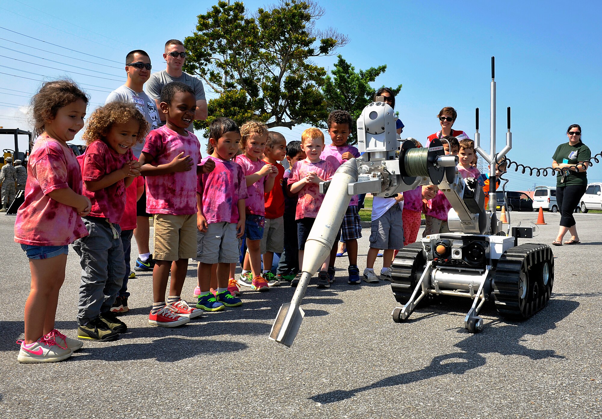 Children from the Niko-Niko Child Development Center, watch as an explosive ordnance disposal robot moves during a Military Child Appreciation Month showcase on Kadena Air Base, Japan, April 17, 2015. Approximately 150 children from the Niko-Niko CDC were able to experience military heavy construction equipment, explosive ordnance disposal robot and other equipment showcased by the 18th Civil Engineer Squadron. (U.S. Air Force photo by Naoto Anazawa)