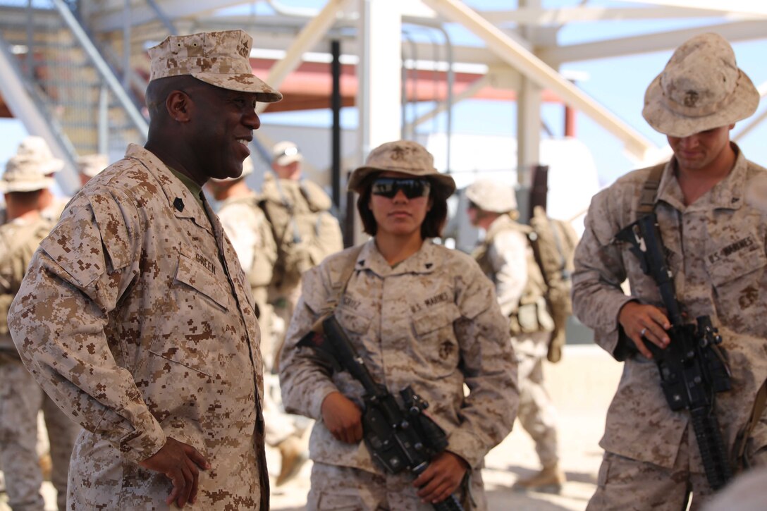 Sergeant Major of the Marine Corps Ronald L. Green, left, addresses Marines with the Ground Combat Element Integrated Task Force during a visit to Range 107, Marine Corps Air Ground Combat Center Twentynine Palms, California, April 18, 2015. From October 2014 to July 2015, the GCEITF will conduct individual and collective level skills training in designated ground combat arms occupational specialties in order to facilitate the standards-based assessment of the physical performance of Marines in a simulated operating environment performing specific ground combat arms tasks. (U.S. Marine Corps photo by Cpl. Paul S. Martinez/Released)