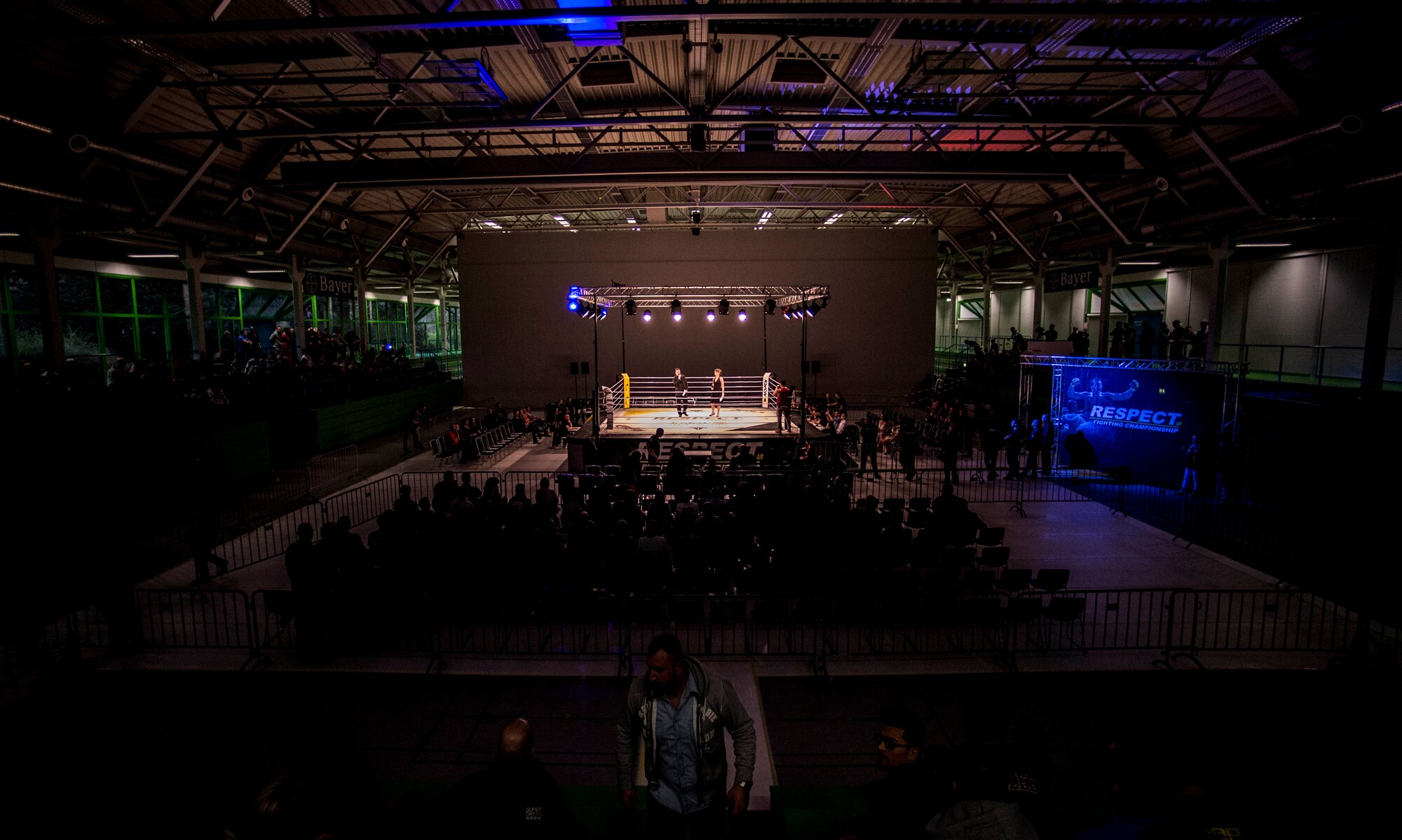 A fighting arena holds two announcers during the 12th Kwon Respect Fighting Championship in Wuppertal, Germany, April 11, 2015. Thirteen fights took place at the event, featuring mixed martial artists, boxers and K-1 kickboxers. (U.S. Air Force photo/Airman 1st Class Timothy Kim)