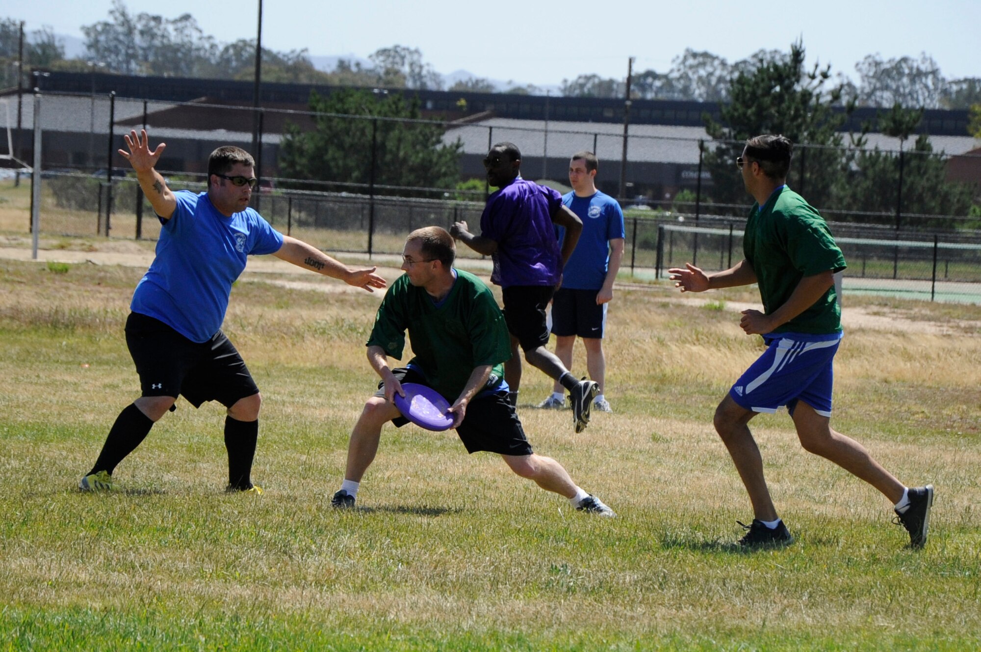 Members of the 30th Space Communications Squadron play ultimate frisbee with members of the 614th Air and Space Communications Squadron during a cyber sports challenge, April 17, 2015, Vandenberg Air Force Base, Calif. The event aimed to build camaraderie while pitting the base’s two communications squadrons, the 614th Air and Space Communications Squadron and the 30th Space Communications Squadron, against each other in a series of friendly, yet competitive, physical competitions. (U.S. Air Force photo by Senior Airman Shane Phipps/Released)