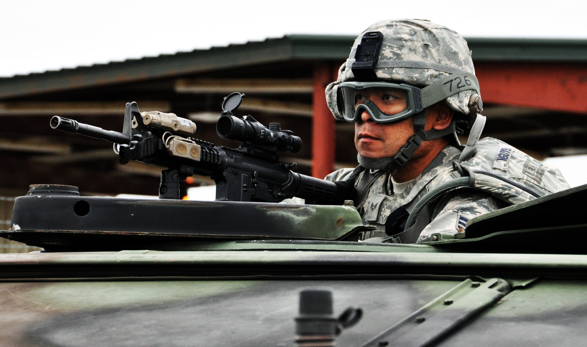 Senior Airman Long Nguyen mans the turret of a High Mobility Multipurpose Wheeled Vehicle (HMMWV) during a convoy operations exercise at Camp Gruber Training Center, Okla., April 15, 2015.  Nguyen, a member of the Air Force Reserve 931st Security Forces Squadron, McConnell Air Force Base, Kan., was participating in a ten-day training exercise at Camp Gruber.  During the exercise, squadron members took part in combat skills training including land navigation, weapons training, tactical movements, convoy operations, base defense, room clearing procedures, foot patrols, military operations on urban terrain (MOUT) and combat lifesaving.  (U.S. Air Force photo by Capt. Zach Anderson)