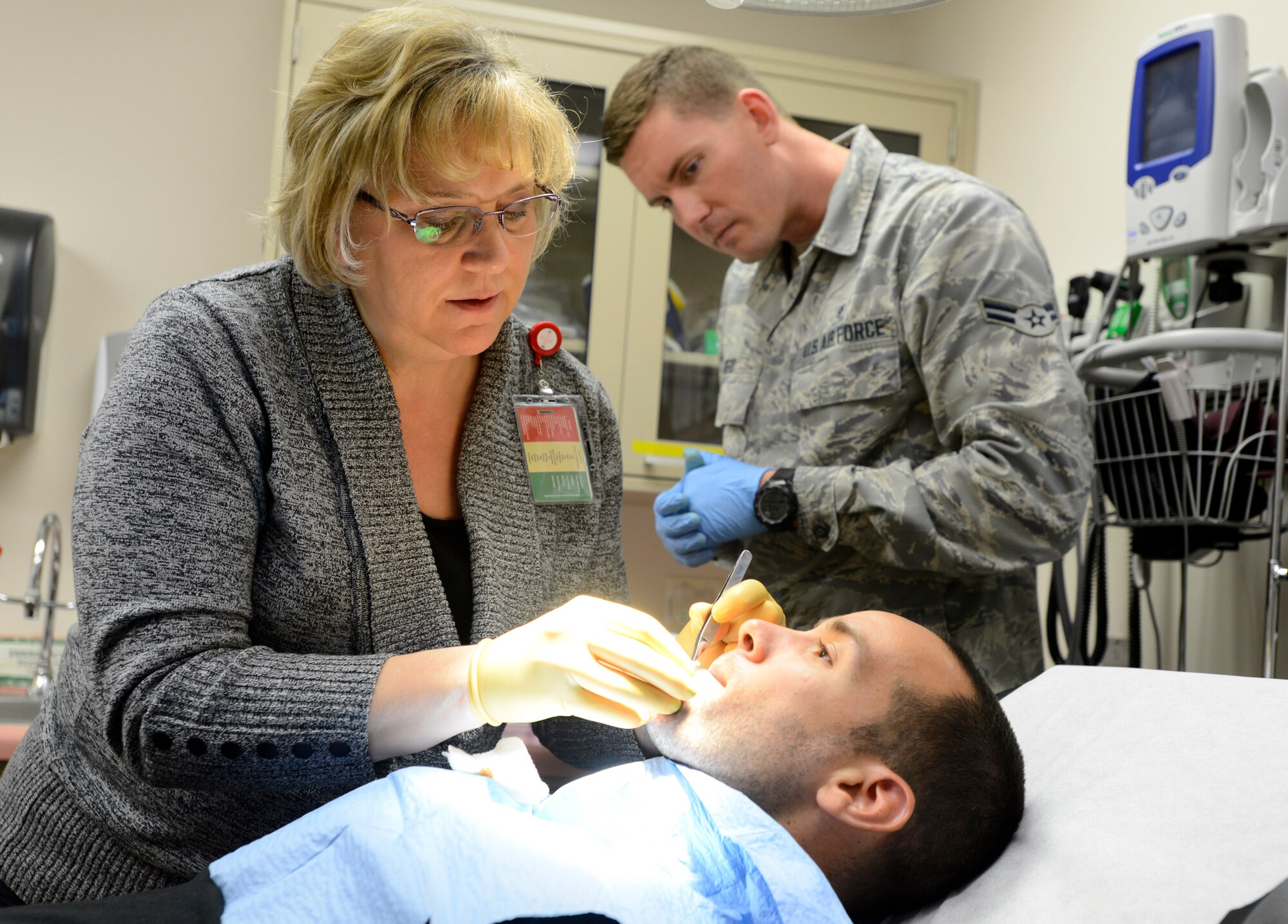 Ilonda Griffee, 22nd Medical Operations Squadron Family Nurse Practitioner, performs a mole-removal procedure, April 20, 2015, at McConnell Air Force Base, Kan. Griffee, is one of three FNPs at Team McConnell and is part of a team who serves more than 11,000 beneficiaries across Team McConnell. (U.S. Air Force photo by Senior Airman Trevor Rhynes)